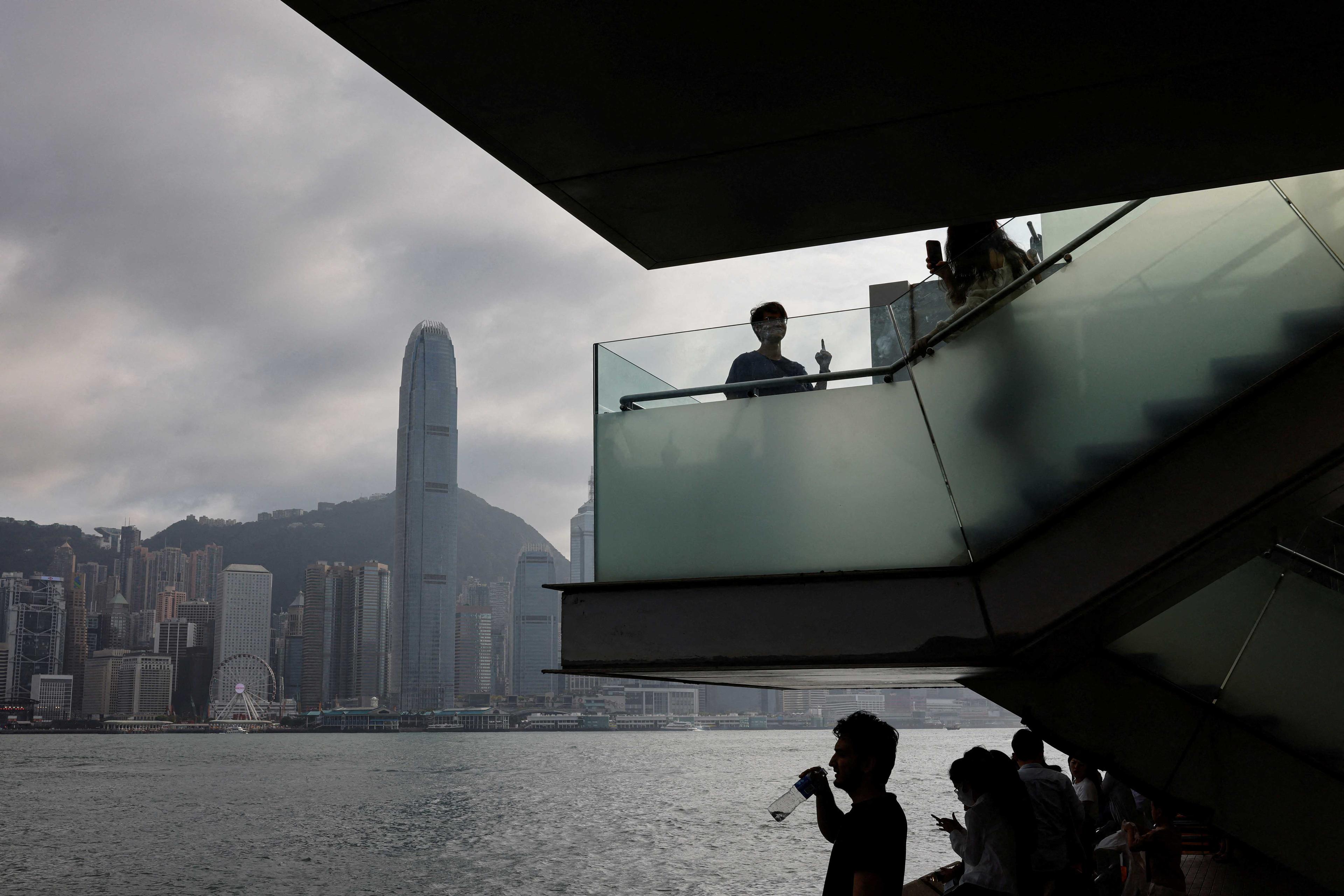 Mainland Chinese tourists look out at the skyline of buildings at Tsim Sha Tsui, in Hong Kong, China May 2. Photo: Reuters