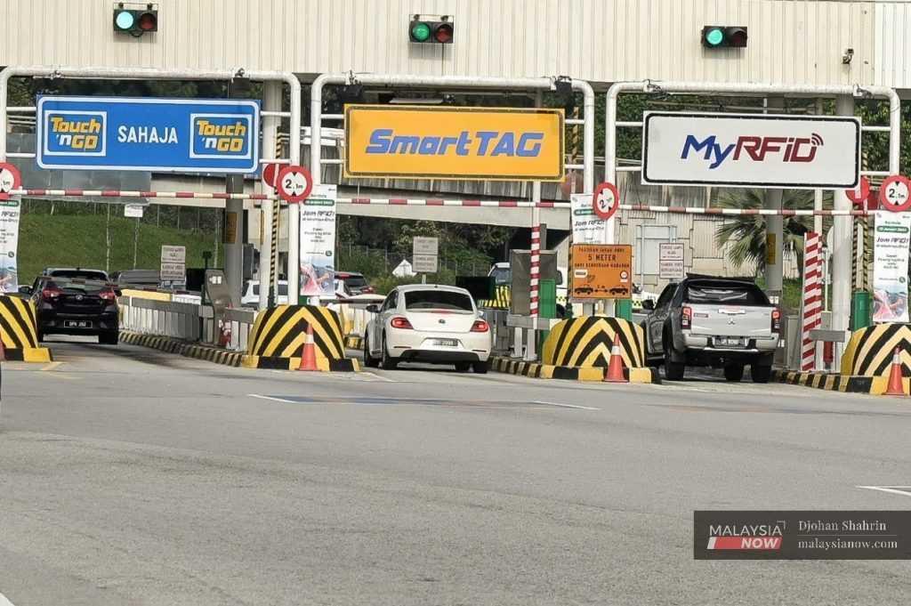Vehicles stop at a toll plaza in this file picture.