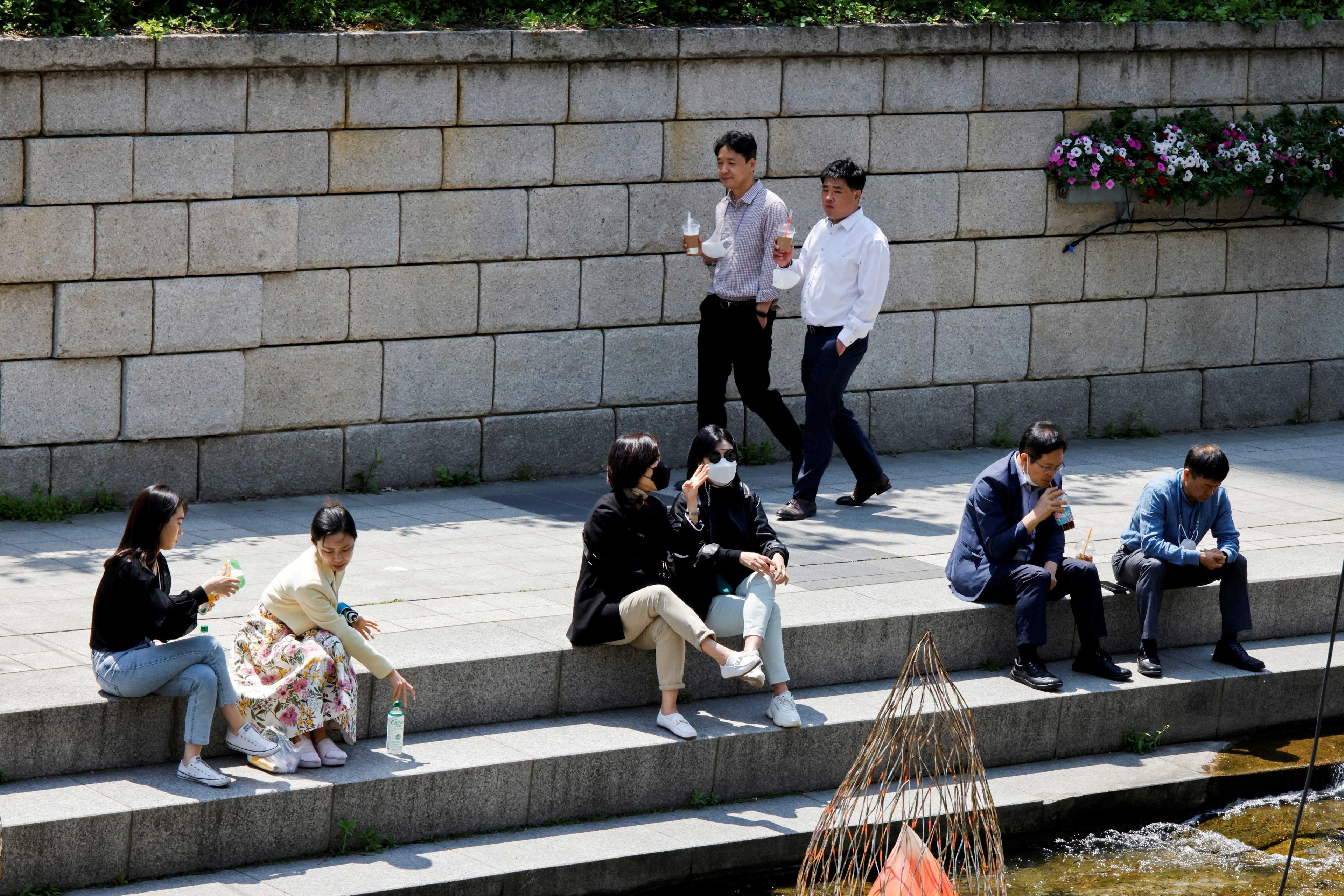 People walk on a sunny spring day in Seoul, South Korea, May 3, 2022. Photo: Reuters