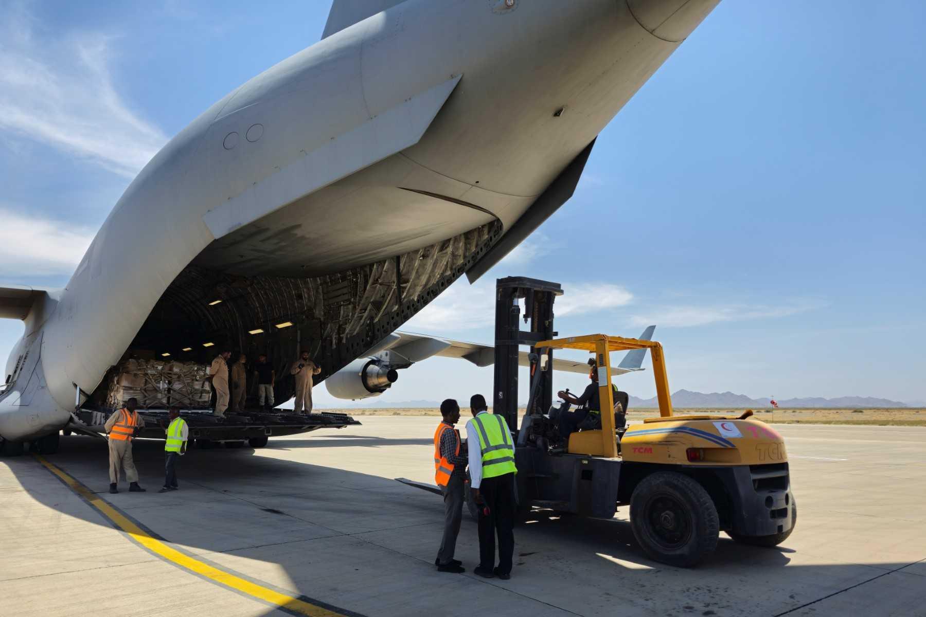 Workers unload aid supplies upon the landing of an Emirati aircraft at Port Sudan airport on May 10, as violence between two rival Sudanese generals continues. Photo: AFP