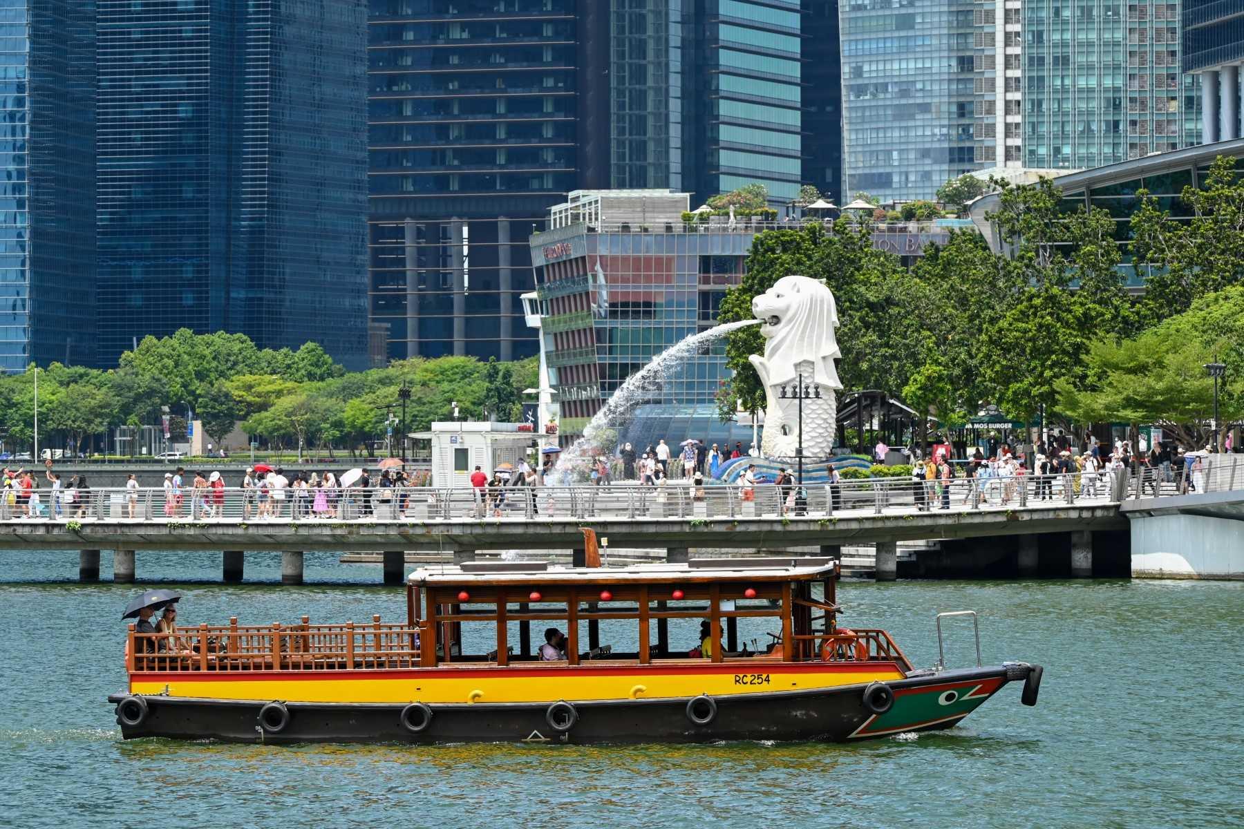 People take pictures on the jetty in front of the Merlion Statue at Marina Bay in Singapore. Photo: AFP
