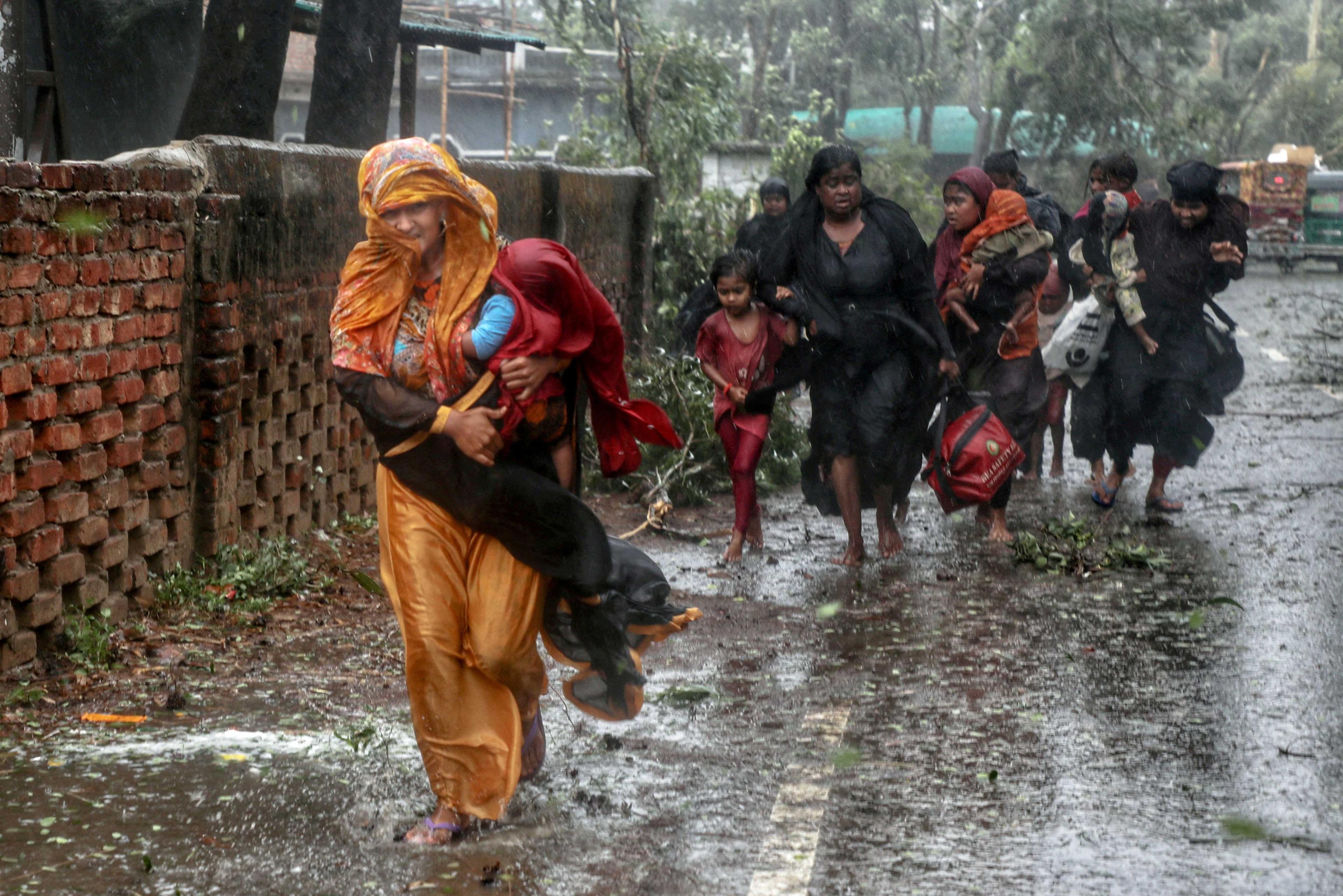 People move from their homes to take shelter in the nearest cyclone shelter at Shah Porir Dwip during the landfall of cyclone Mocha in Teknaf, Bangladesh, May 14. Photo: Reuters