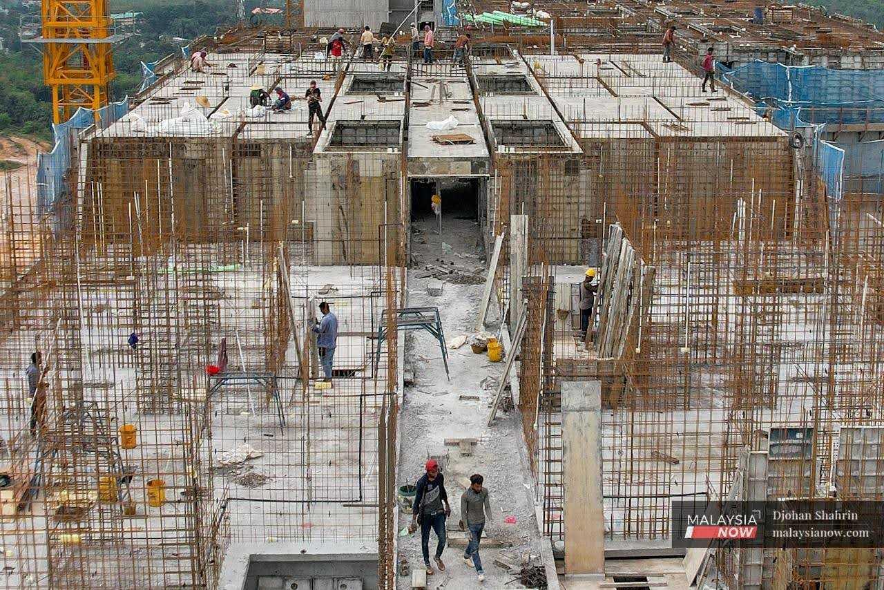 Foreign workers carry out their tasks at a construction site in Selangor. 