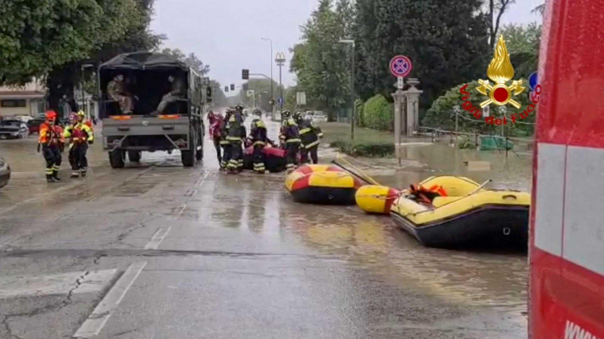 Firefighters and rescuers are seen next to boats during rescue operations in Faenza, Italy after floods hit Italy's northern Emilia-Romagna region, in this handout image released May 17. Photo: Reuters