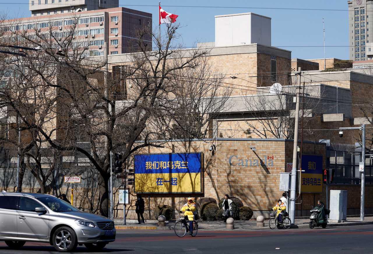 People walk past billboards in support of Ukraine following Russia's invasion of the country, outside the Canadian embassy in Beijing, March 2, 2022. Photo: Reuters