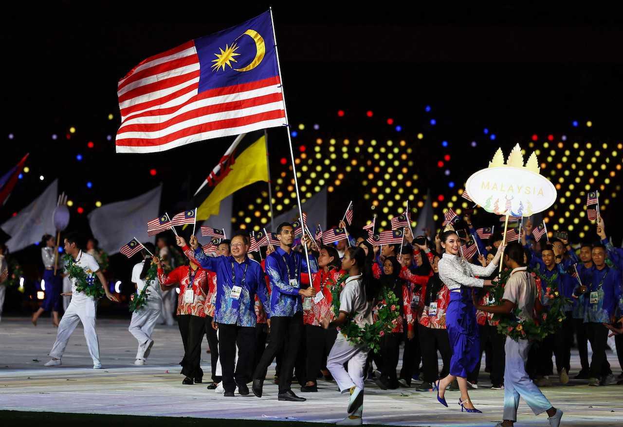 The Malaysian contingent wave during the parade of nations at the opening ceremony of the SEA Games at Morodok Techo National Stadium, Phnom Penh, Cambodia, May 5. Photo: Reuters