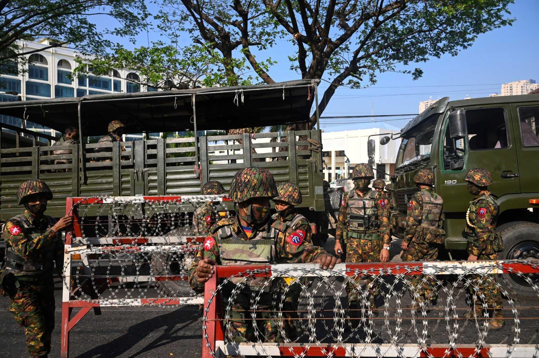 Soldiers prepare to block a road in front of the Central Bank of Myanmar in Yangon on Feb 15, 2021, as Myanmar's junta deployed extra troops around the country as part of the ongoing military coup. Photo: AFP 