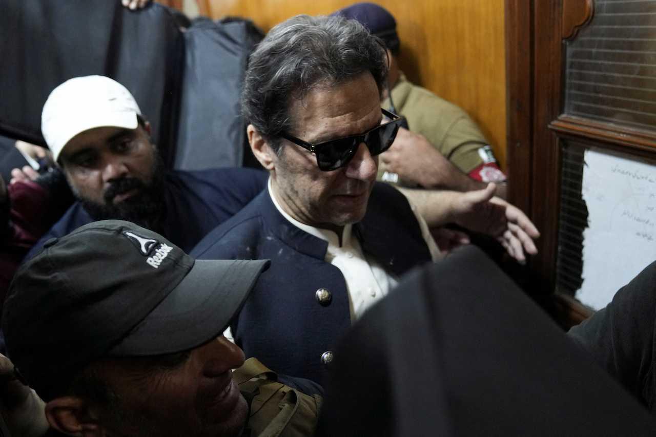 Security officers escort Pakistan's former prime minister Imran Khan as he appears in Lahore High Court, in Lahore, May 19. Photo: Reuters