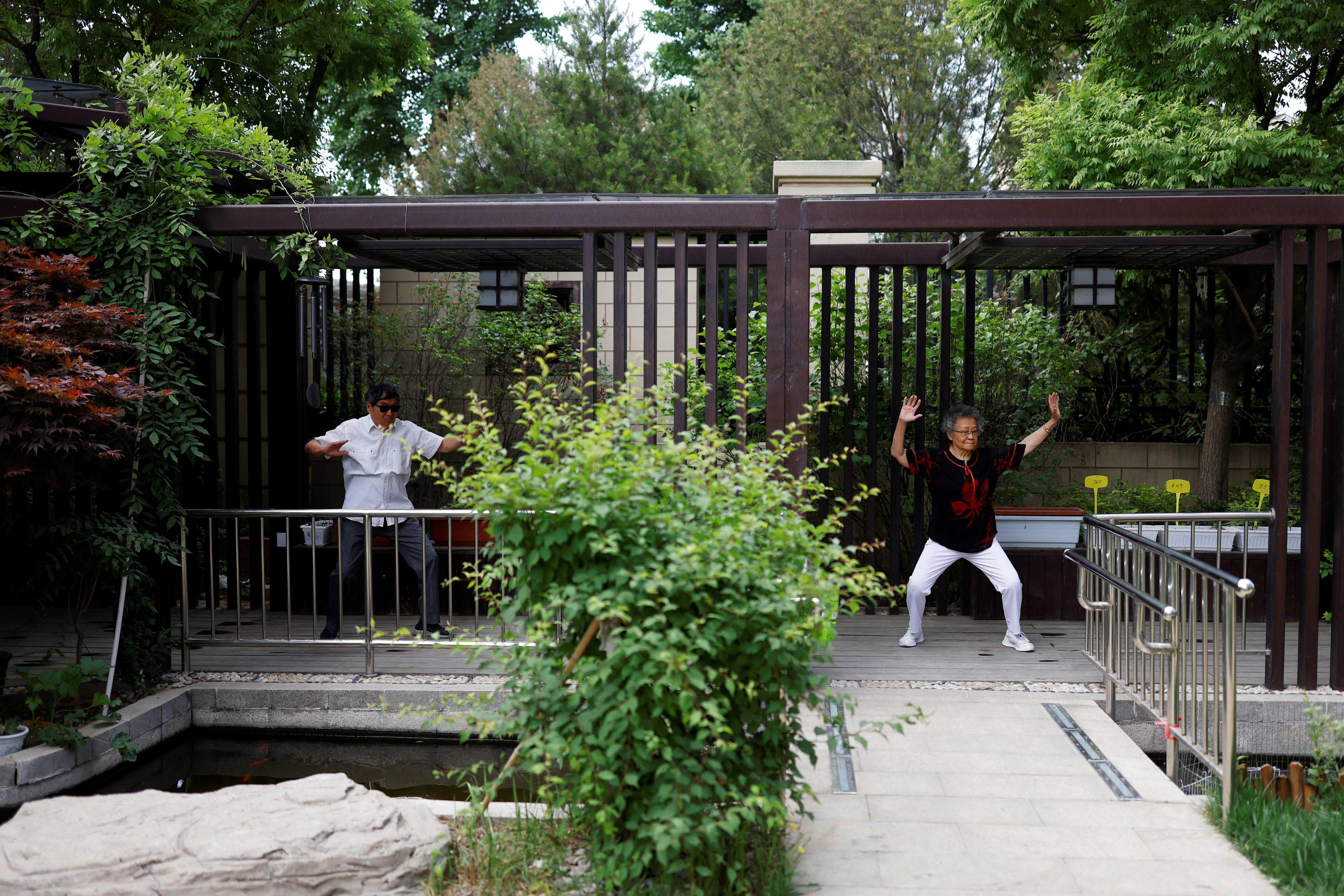 An elderly couple exercise outdoor at Heyuejia, a care home for the elderly, in Beijing, China May 26, 2021. Photo: Reuters