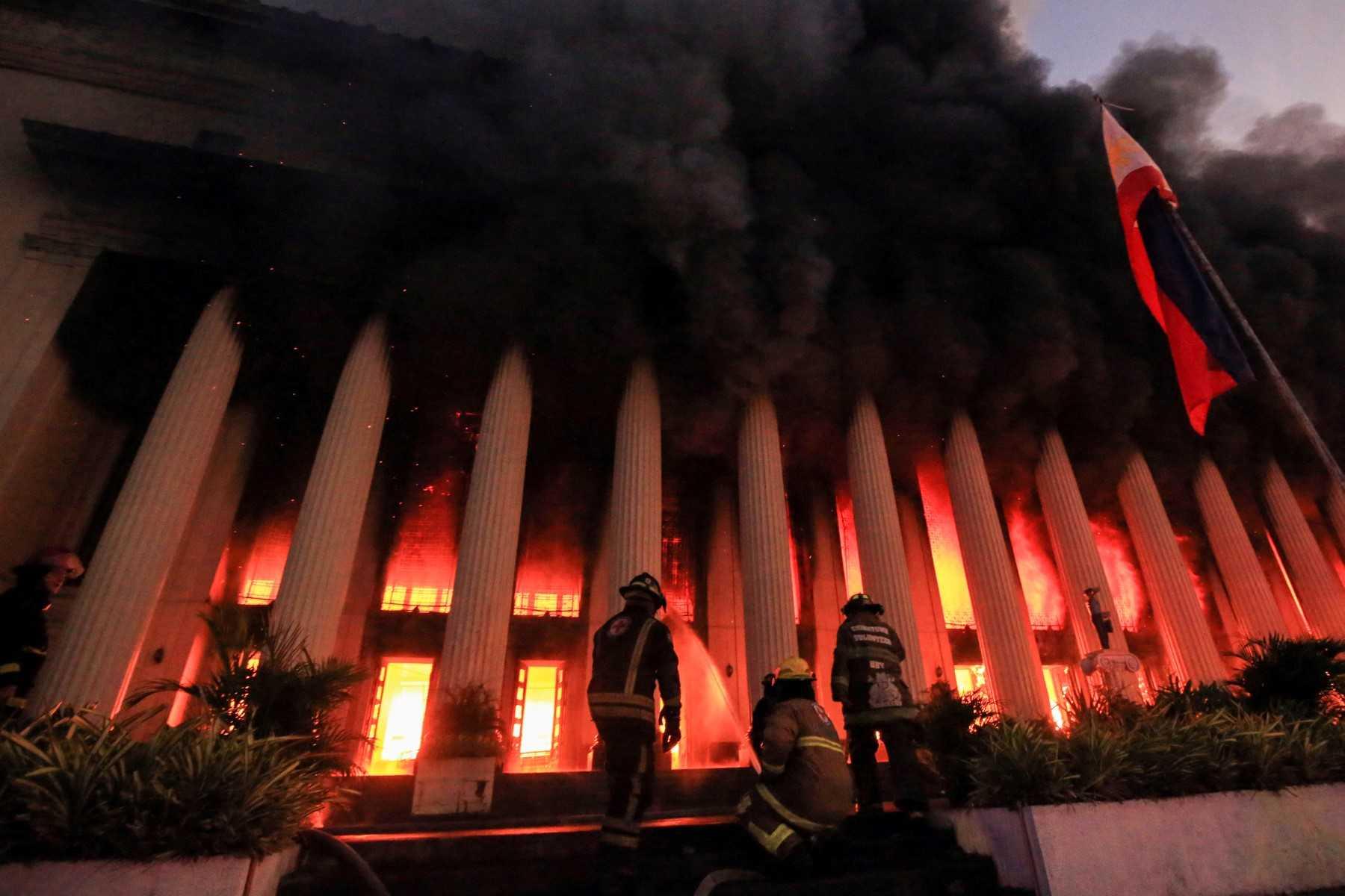 Firefighters douse a fire at the Post Office building in Manila on May 22. Photo: Reuters