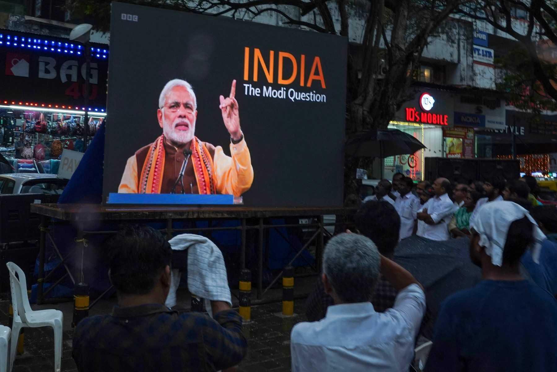 People watch the BBC documentary 'India: The Modi Question', on a screen installed at the Marine Drive junction under the direction of the district congress committee, in Kochi on Jan 24. Photo: AFP