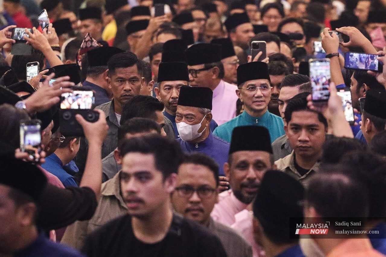 Selangor Perikatan Nasional chairman Mohamed Azmin Ali arrives with Muhyiddin Yassin for an open house event in Shah Alam, May 21. 
