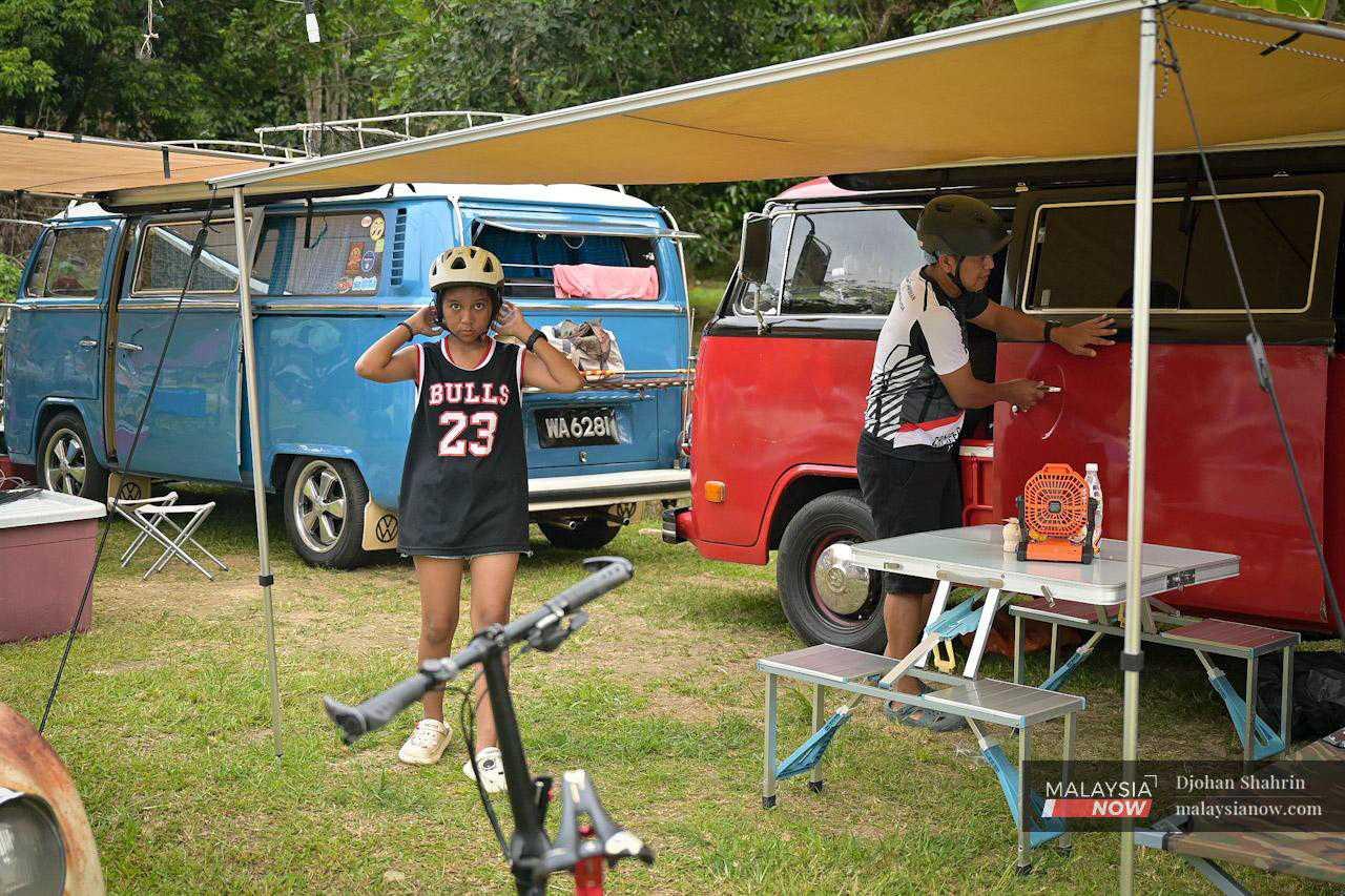 Other participants prepare to enjoy some recreational activities at the campsite, after setting up their Kombi vehicles to be used as caravans for the next few days. 
