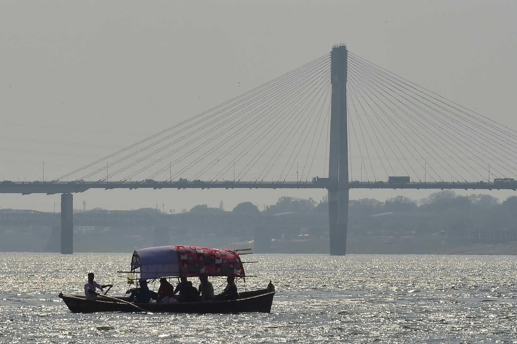 People enjoy a boat ride on the waters of the Sangam, the confluence of the rivers Ganges, Yamuna and the mythical Saraswati in Prayagraj on May 6. Photo: AFP