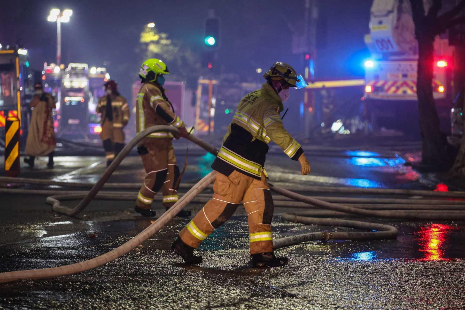 Firemen work at the scene of a fire at a building in Sydney on May 25. Photo: AFP 