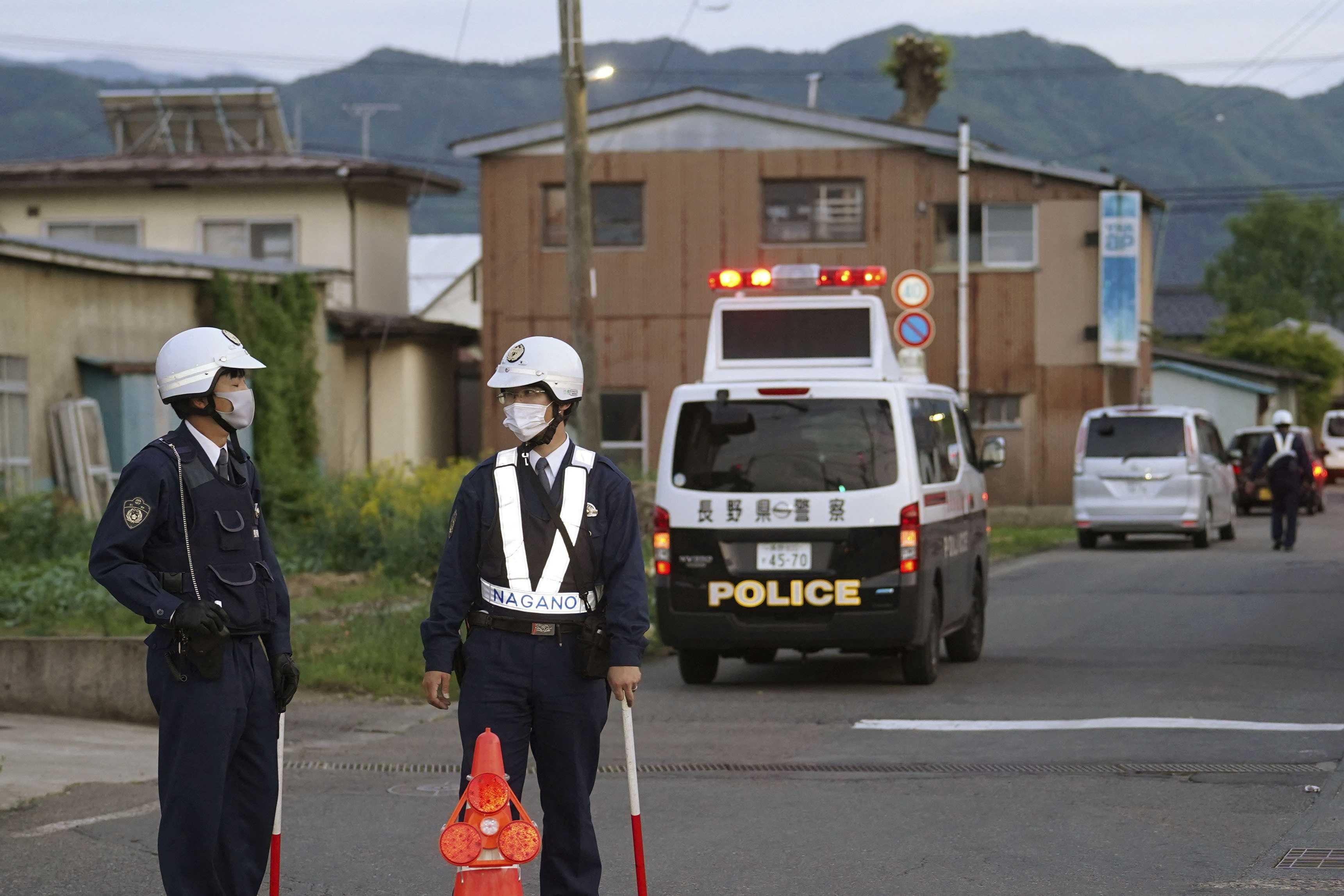 Police officers stand near the scene of a stabbing and shooting incident in Nakano, Nagano Prefecture, Japan, in this photo taken by Kyodo on May 25. Photo: Reuters