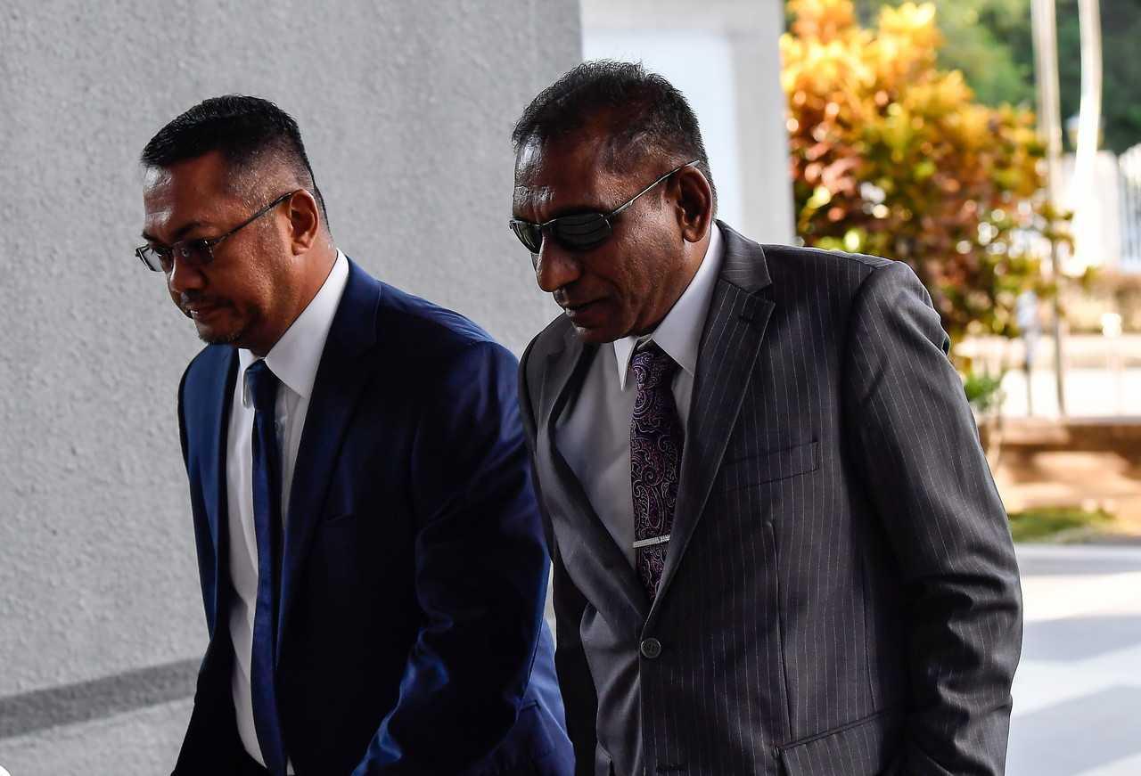Former treasury secretary-general Mohd Irwan Serigar Abdullah (right) attends the criminal breach of trust hearing he faces along with former prime minister Najib Razak, involving payments to the International Petroleum Investment Company at the High Court today. Photo: Bernama.