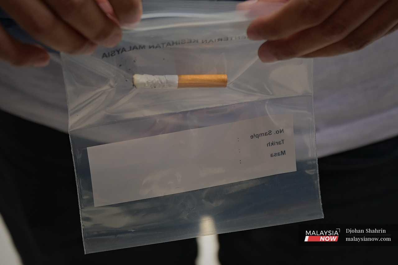 Cigarette stubs are sealed in a clear plastic bag as evidence of the offence. 
