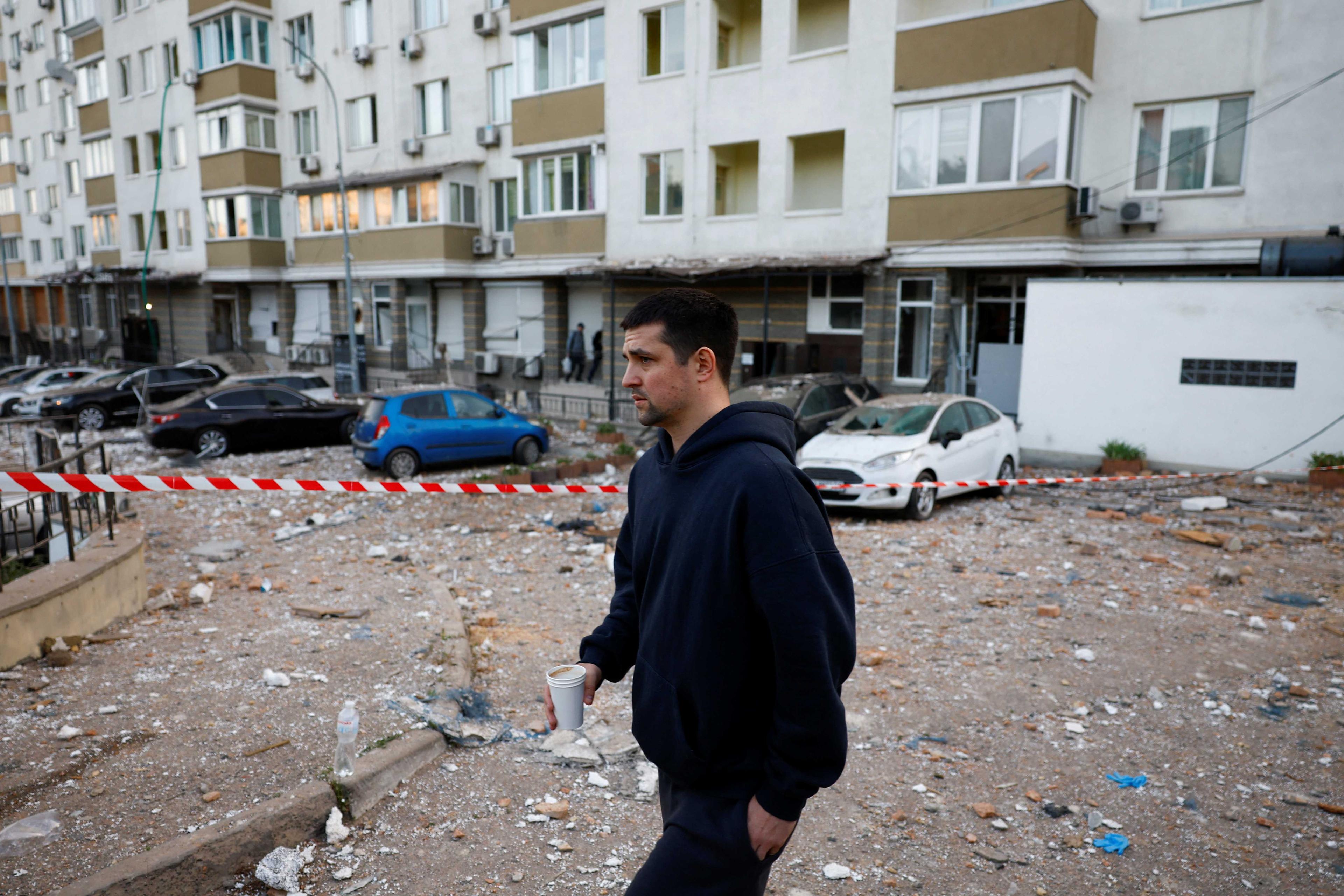 A resident walks near an apartment damaged during a massive Russian drone strike, amid Russia’s attack on Ukraine, in Kyiv, Ukraine May 30. Photo: Reuters