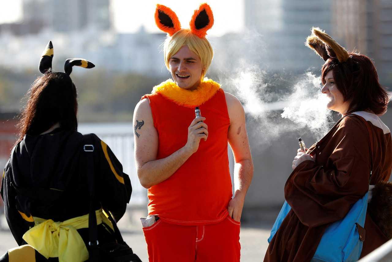 Visitors in costume use their vapes before entering the London Comic Con, at the ExCel exhibition centre in east London, Britain, Oct 27, 2017. Photo: Reuters