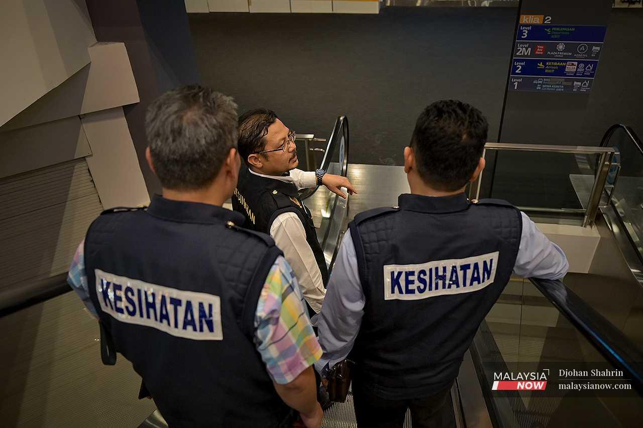 Enforcement personnel from the Selangor health department carry out checks at klia2 in Sepang under Ops Mega Bersepadu, an initiative to monitor public compliance with smoking regulations. 
