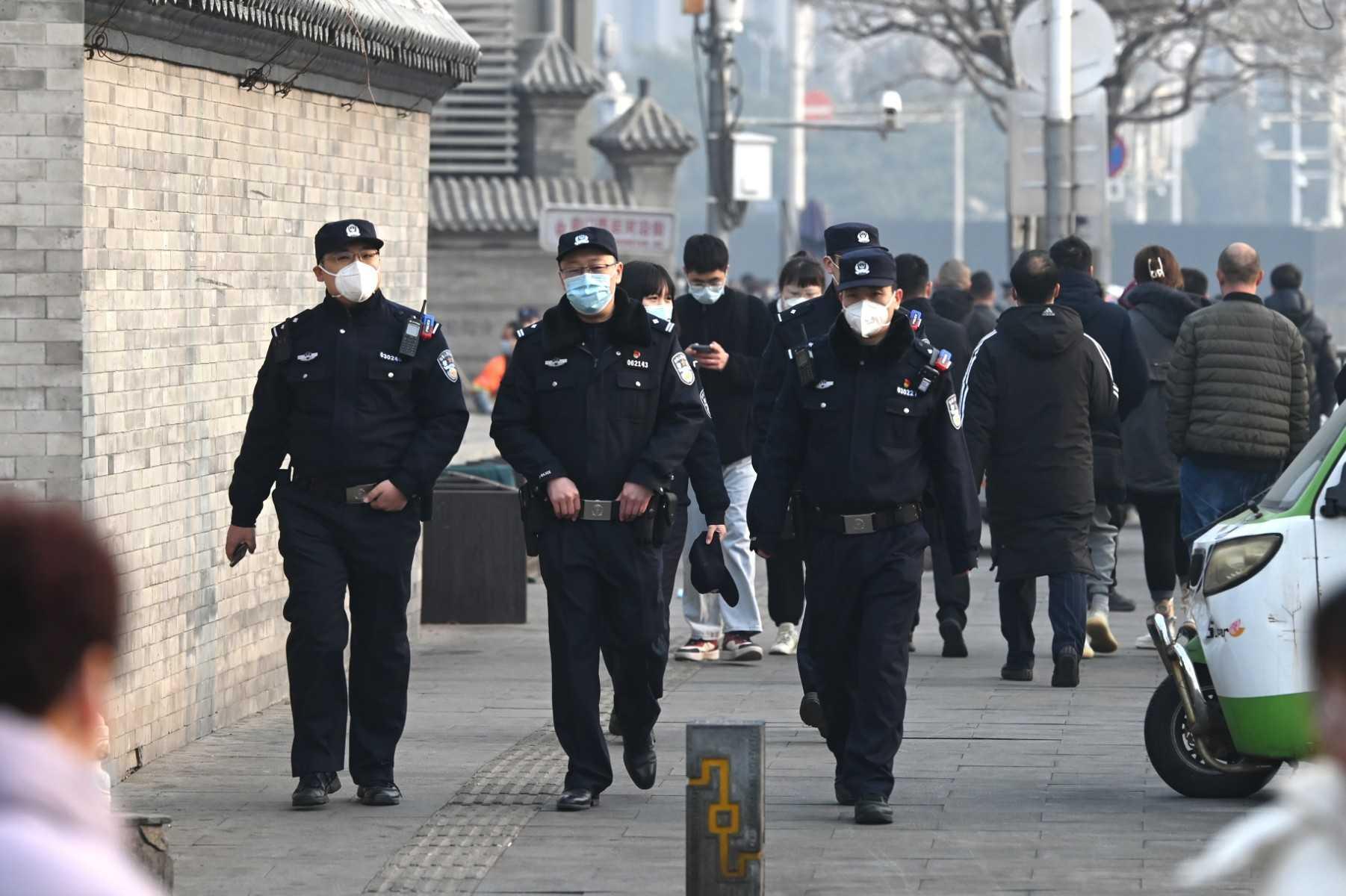 Police officers patrol south of the Great Hall of the People before the opening session of the National People’s Congress in Beijing on March 5. Photo: AFP
