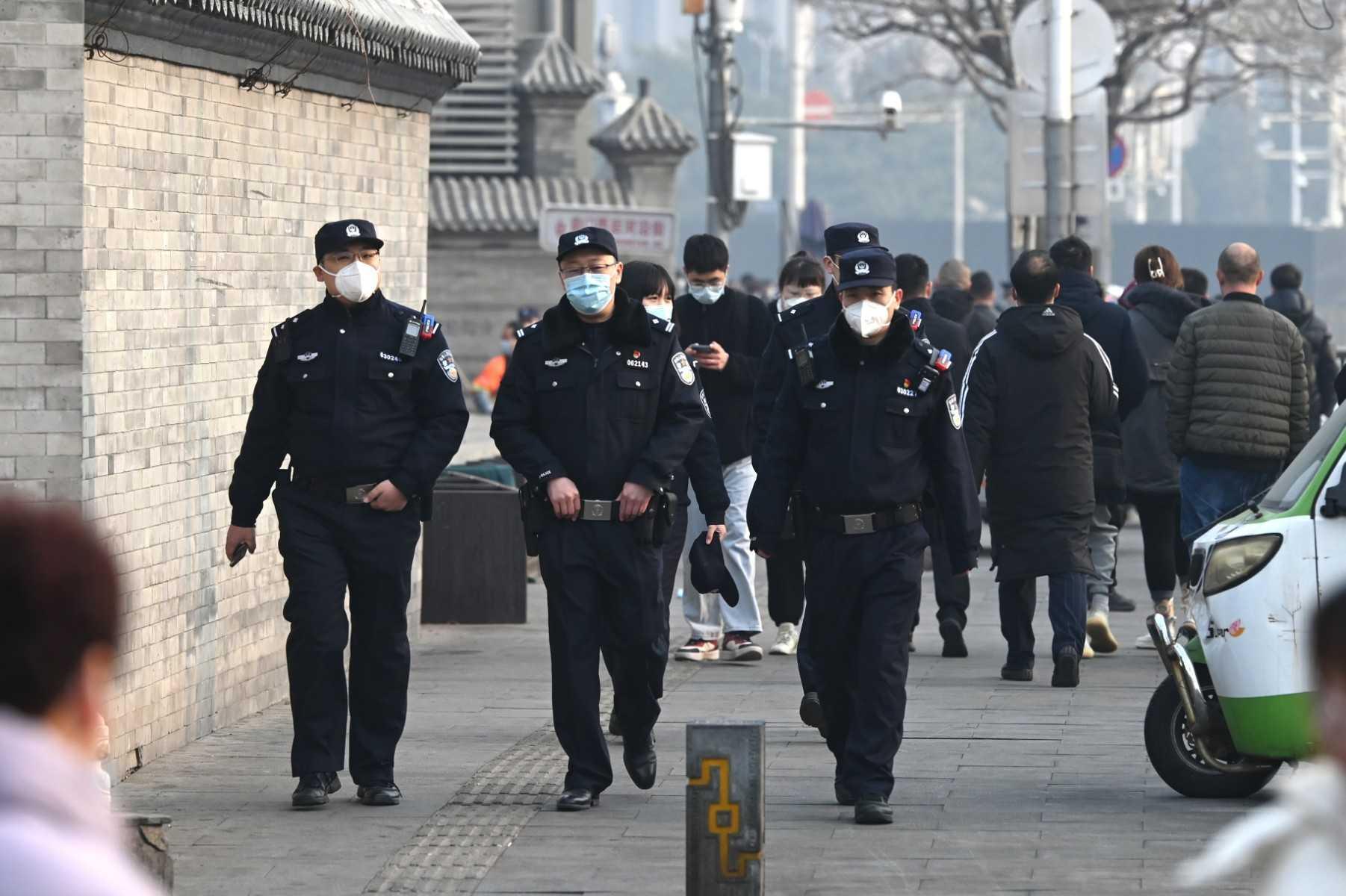 Police officers patrol south of the Great Hall of the People before the opening session of the National People’s Congress in Beijing on March 5. Photo: AFP 