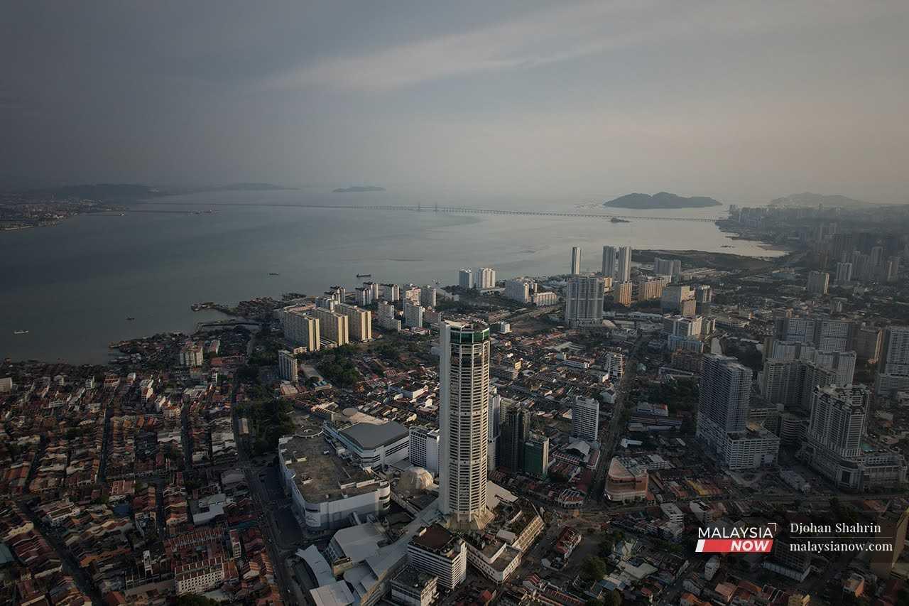 An aerial view of the Komtar building and the iconic Penang Bridge. 
