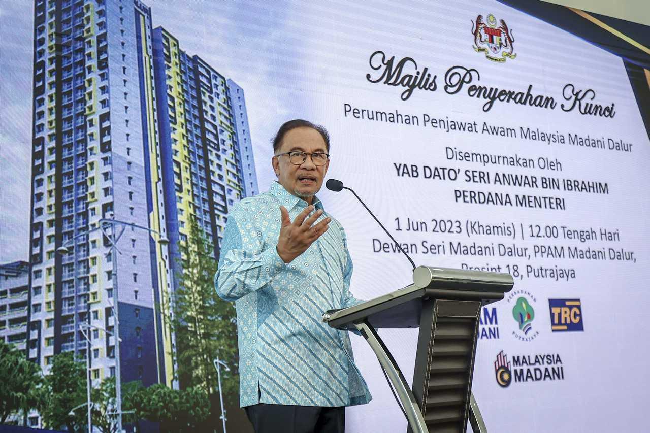 Prime Minister Anwar Ibrahim speaks during the key handover ceremony of the Madani Dalur housing for civil servants in Putrajaya, today. Photo: Bernama