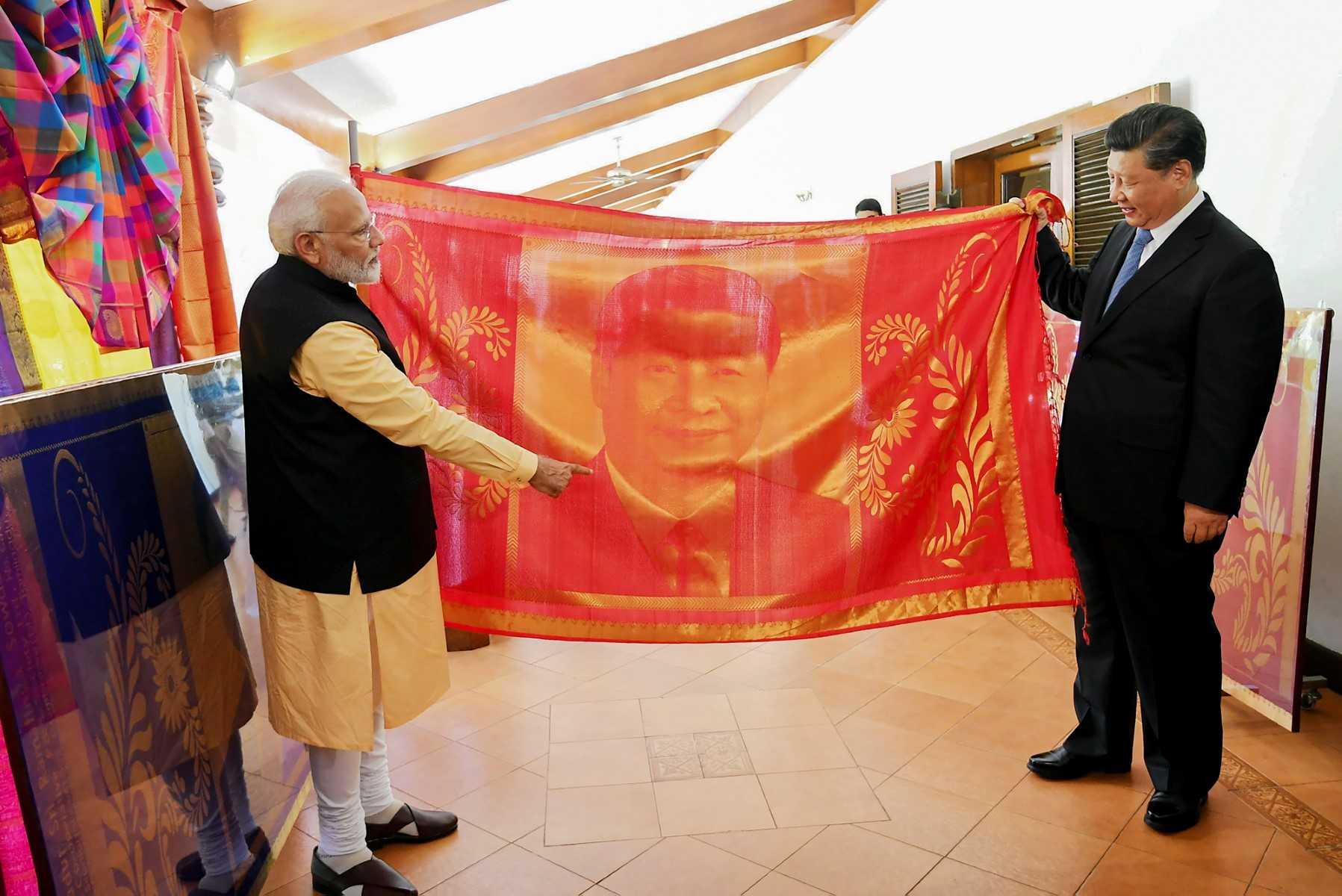 In this handout photo taken on Oct 12, 2019, India's Prime Minister Narendra Modi exchanges gifts with China's President Xi Jinping in Mahabalipuram in Tamil Nadu state. Photo: AFP