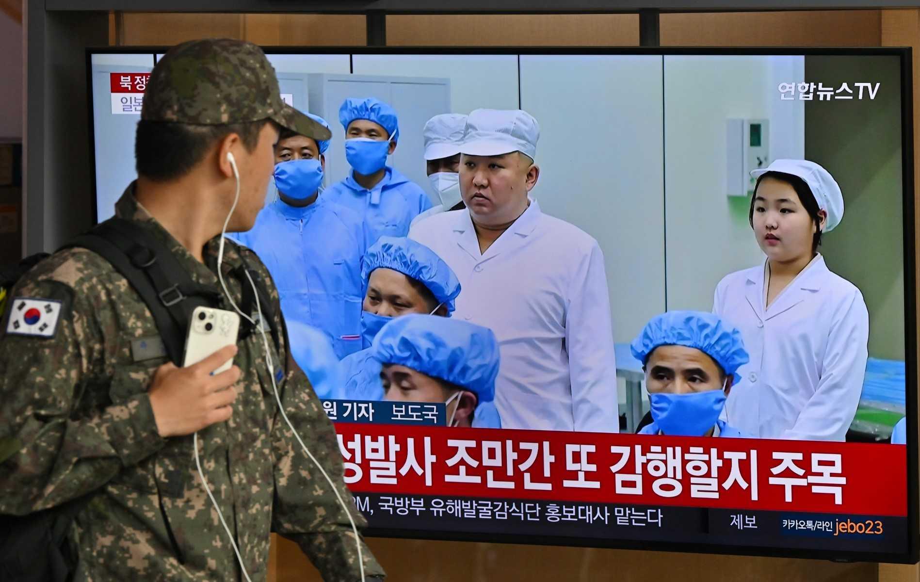 A South Korean soldier walks past a television screen showing a news broadcast with file footage of North Korea's leader Kim Jong Un, at the Seoul Railway Station in Seoul on May 31. Photo: AFP