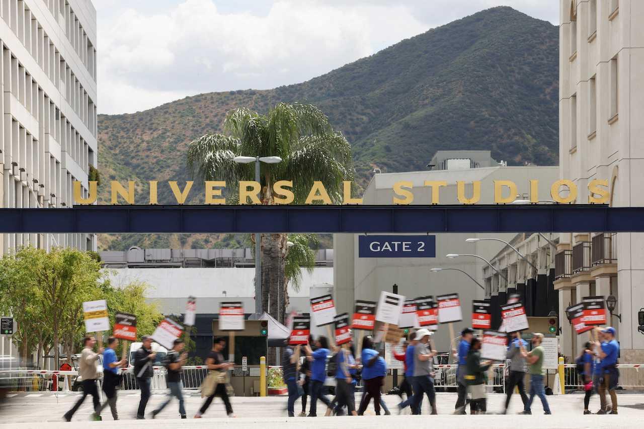 Workers and supporters of the Writers Guild of America protest outside Universal Studios Hollywood after union negotiators called a strike for film and television writers, in the Universal City area of Los Angeles, California, May 3. Photo: Reuters