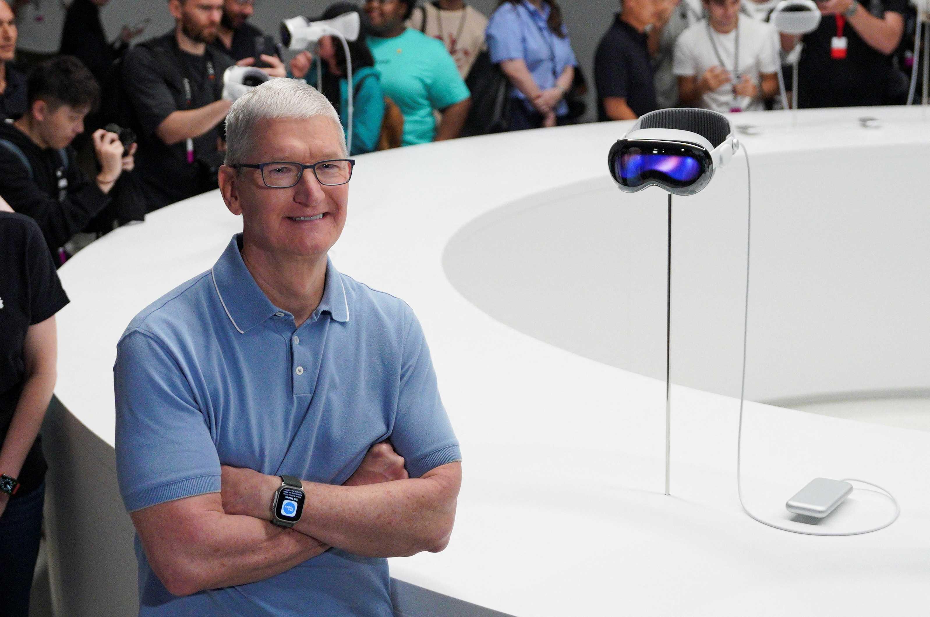 Apple CEO Tim Cook stands next to Apple's Vision Pro headset at Apple's annual Worldwide Developers Conference at the company's headquarters in Cupertino, California, US June 5. Photo: Reuters