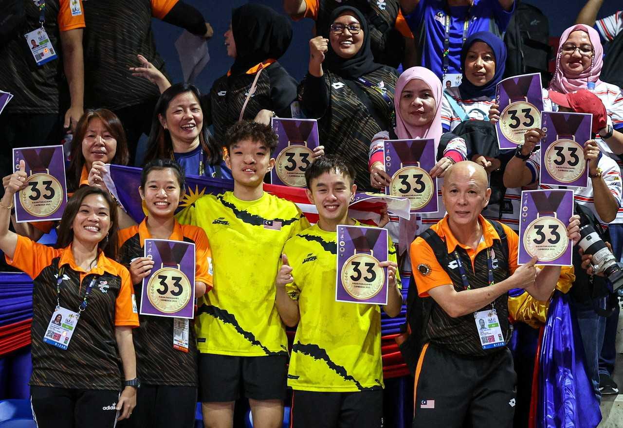 Penyokong Malaysia memegang poster yang menunjukkan angka '33' selepas kontinjen Sukan Para Asean mencapai sasaran 33 pingat emas di Stadium Morodok Techo di Phnom Penh, 6 Jun. Gambar: Bernama