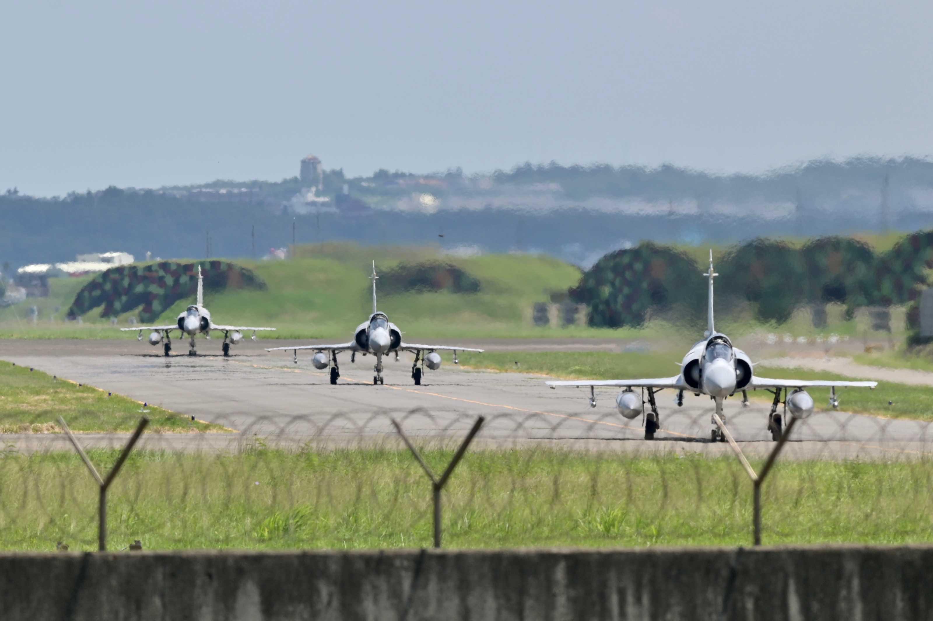 Three French-made Mirage 2000 fighter jets taxi on a runway in front of a hangar at the Hsinchu Air Base in Hsinchu on Aug 5, 2022. Photo: AFP