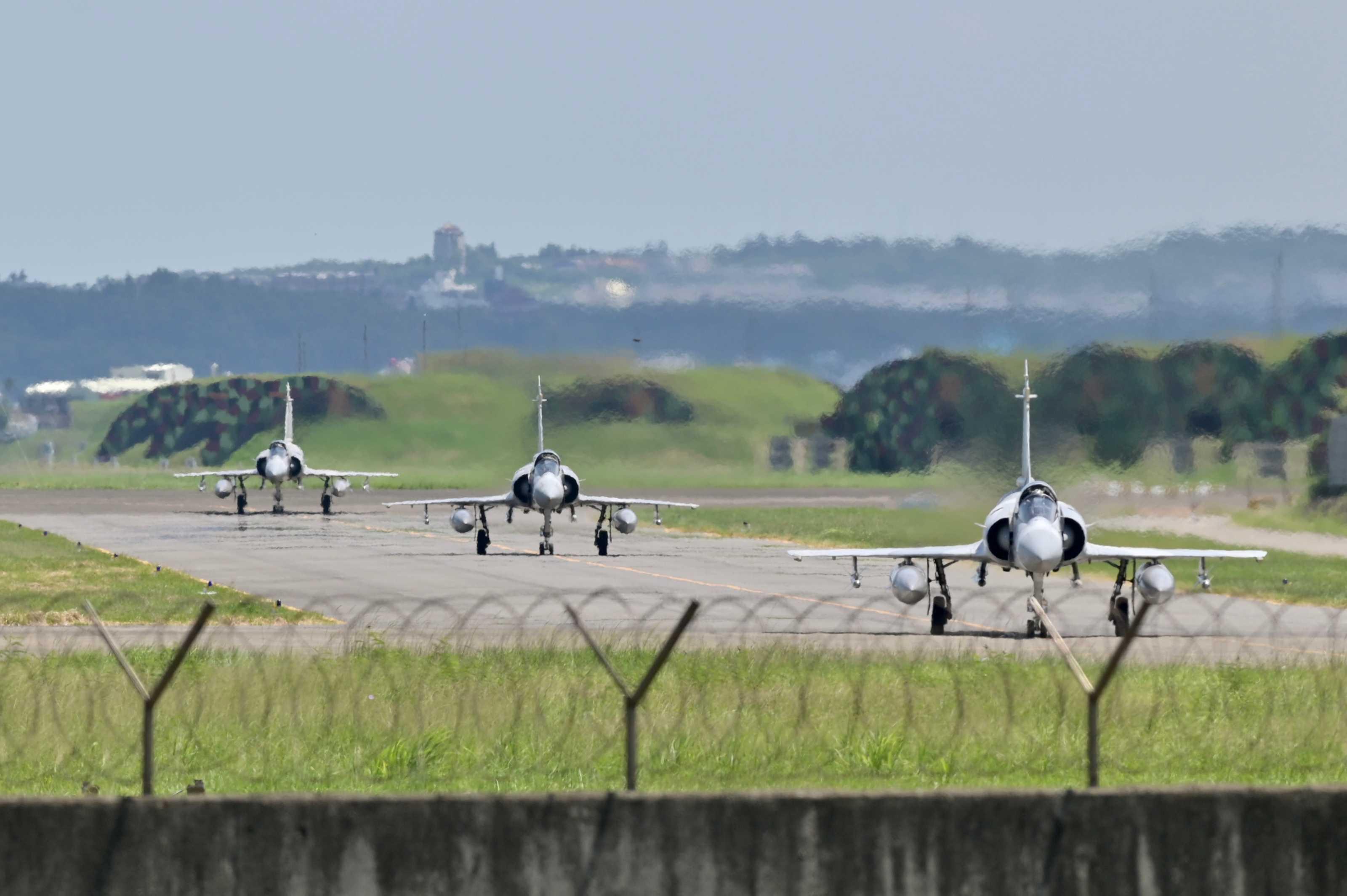Three French-made Mirage 2000 fighter jets taxi on a runway in front of a hangar at the Hsinchu Air Base in Hsinchu on Aug 5, 2022. Photo: AFP 