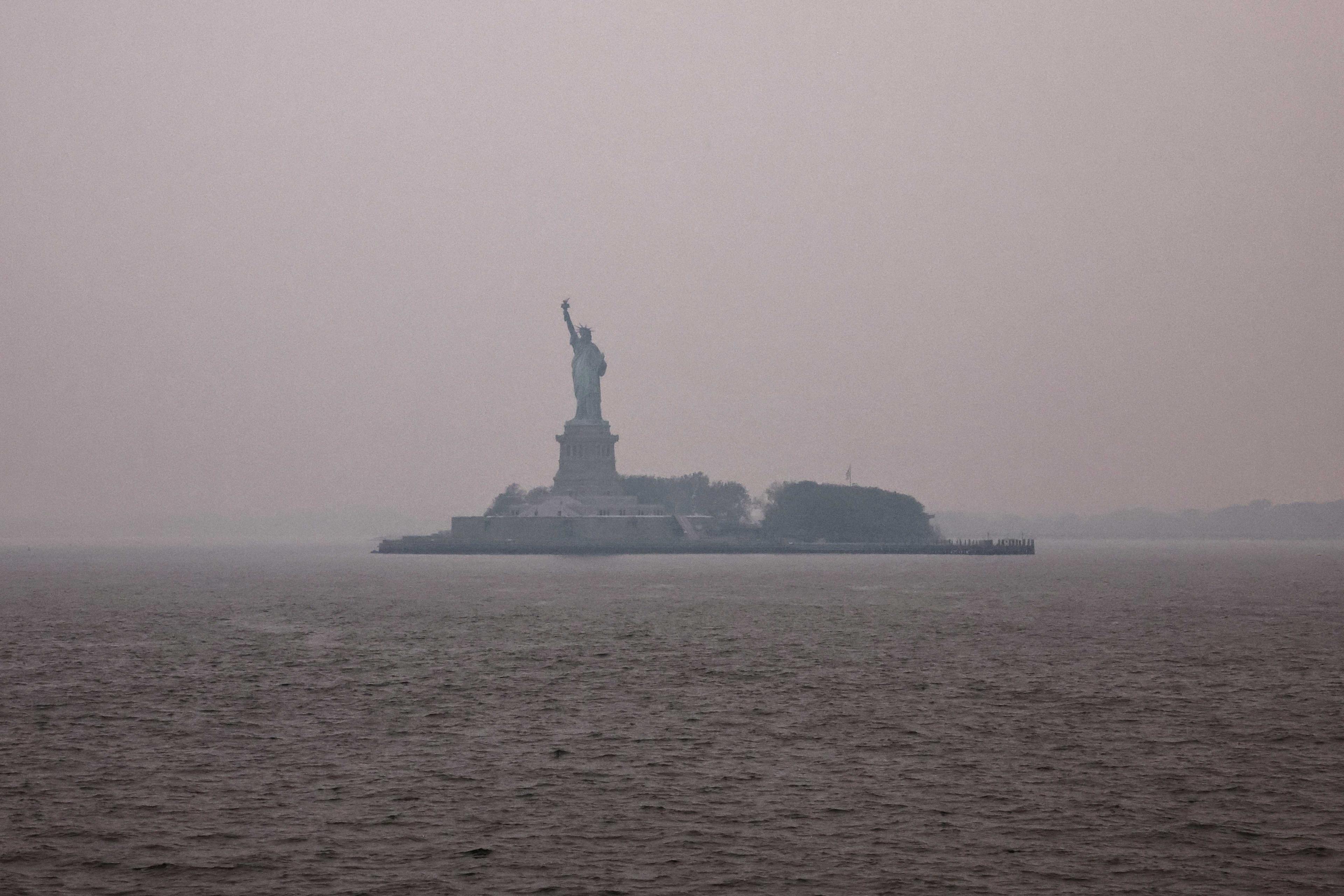 The Statue of Liberty is covered by haze and smoke caused by wildfires in Canada, in New York, US, June 7. Photo: Reuters