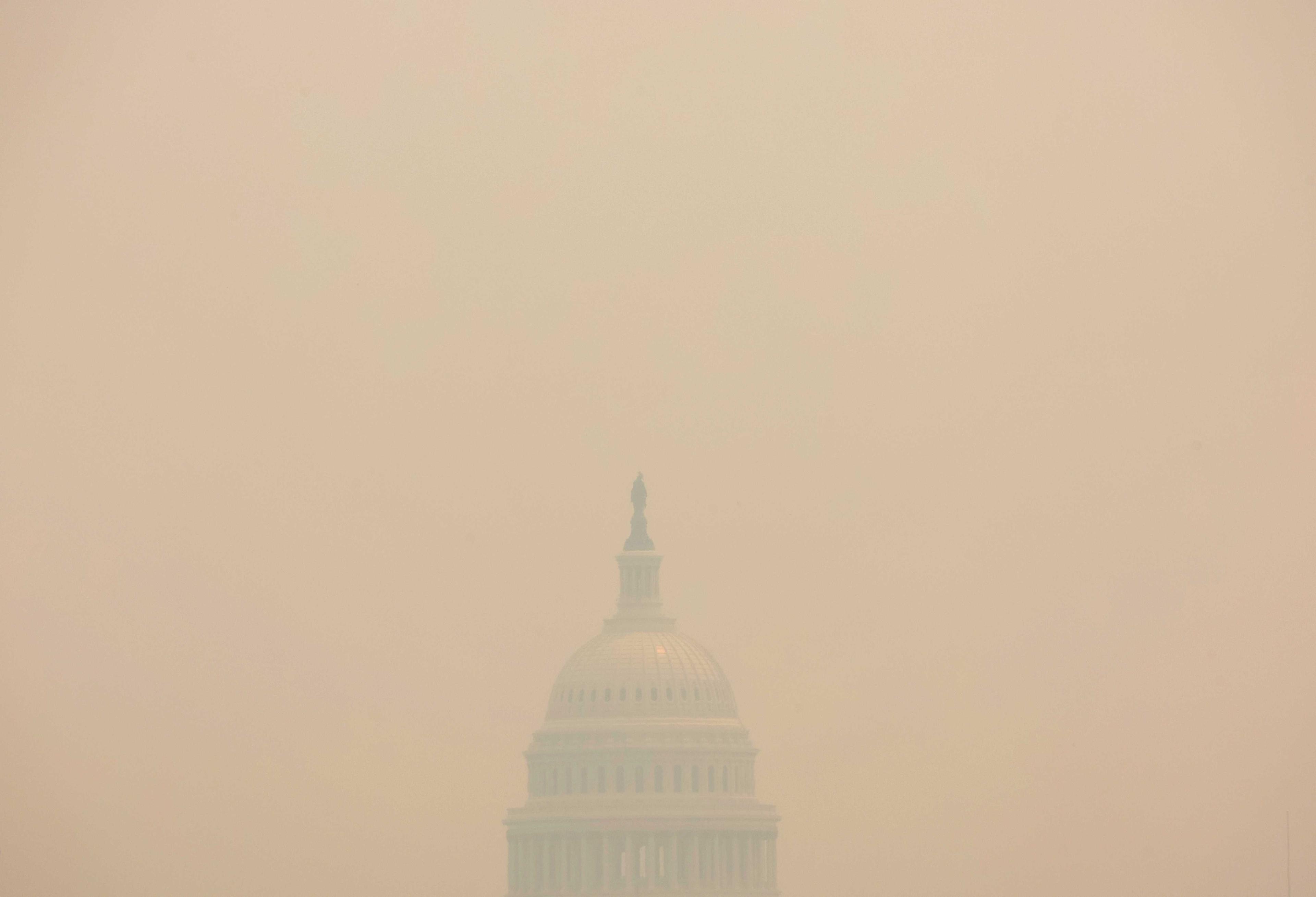 The US Capitol building is seen shrouded in haze and smoke caused by wildfires in Canada, in this view from the National Mall in Washington, US, June 8. Photo: Reuters