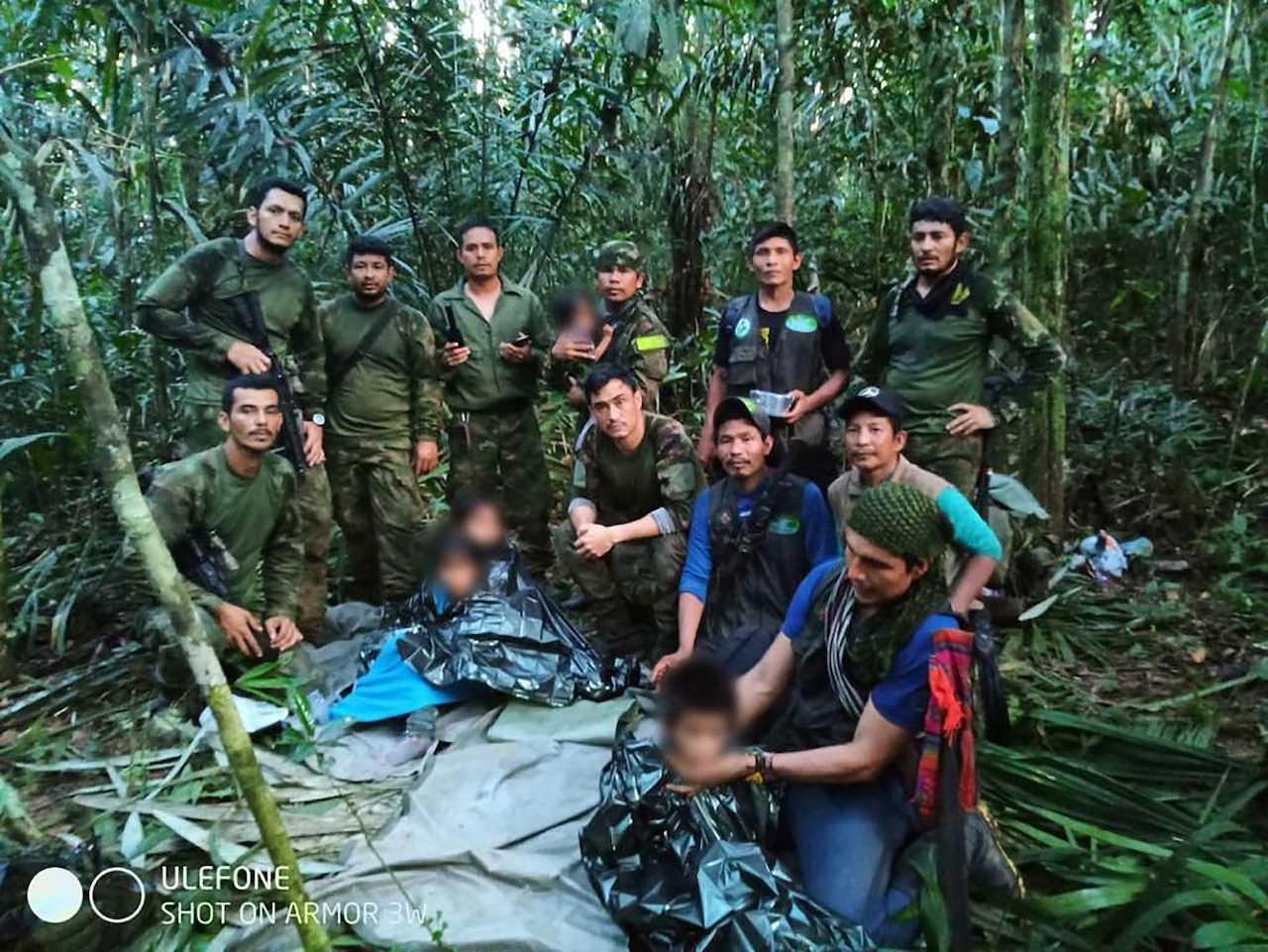 Colombian military soldiers pose for a photo after the rescue of child survivors from a Cessna 206 plane that crashed on May 1 in the jungles of Caqueta, in this handout photo released June 9. Photo: Reuters