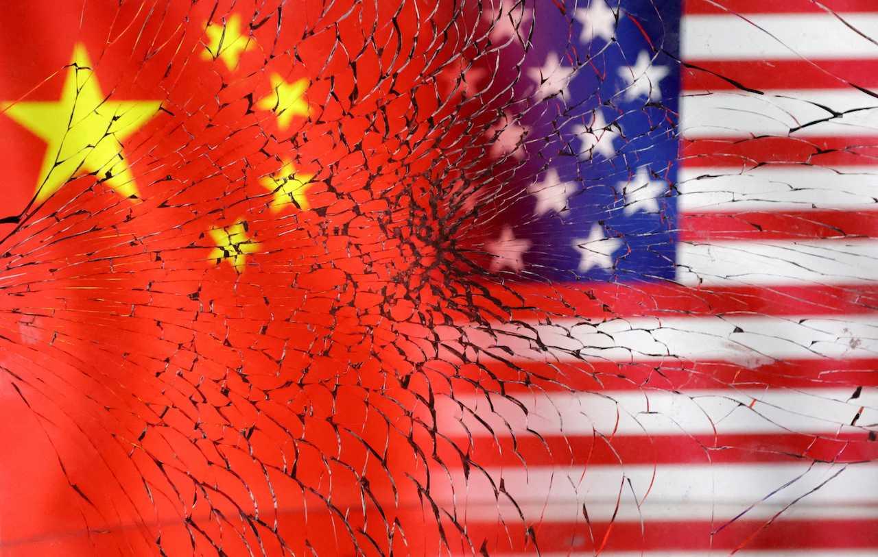 US and Chinese flags seen through broken glass in this illustration taken Jan 30. Photo: Reuters