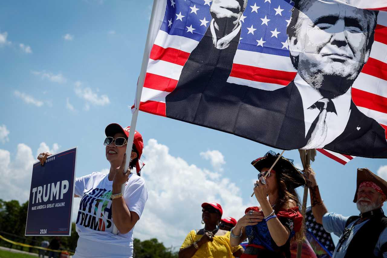 Supporters of former US president Donald Trump gather outside his Mar-a-Lago resort, as he is to appear in a federal court in Miami on classified document charges, in Palm Beach, Florida, June 11. Photo: Reuters