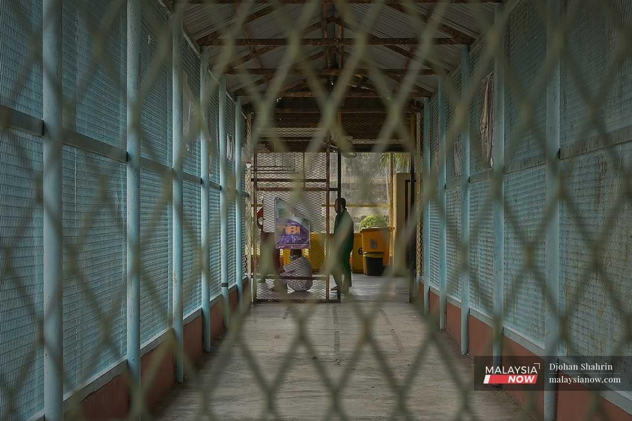 An inmate waits in a gated area at Kajang Prison, where former prime minister Najib Razak is serving a 12-year sentence for corruption.