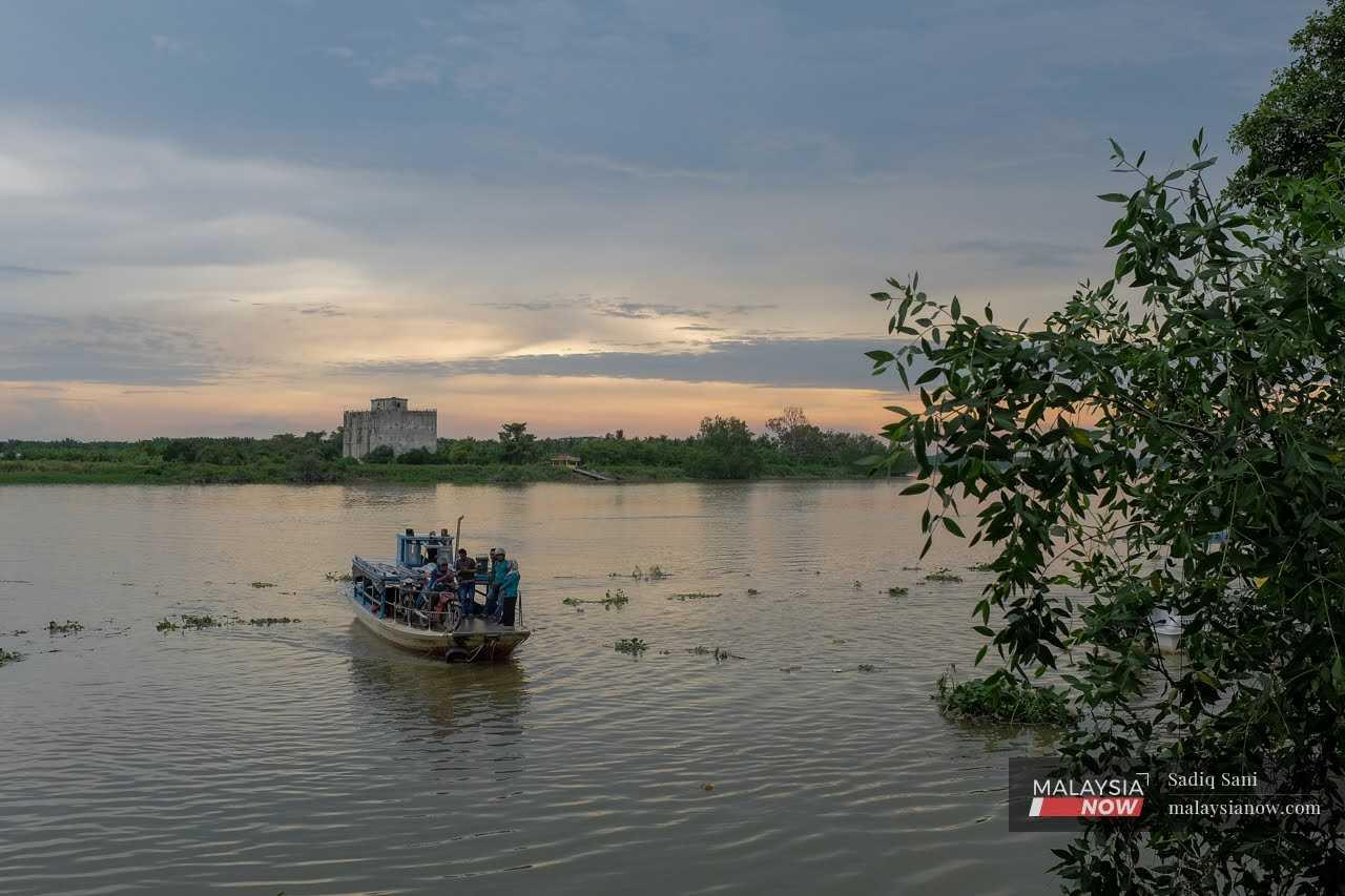 Water taxi carrying passengers and motorcycles cruise across the Sungai Perak in Teluk Intan in this file picture.
