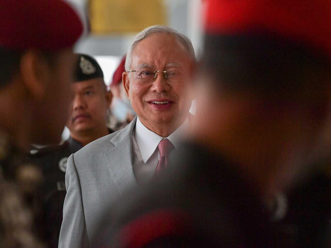 Former prime minister Najib Razak, escorted by security personnel at an appearance in court. Photo: Bernama