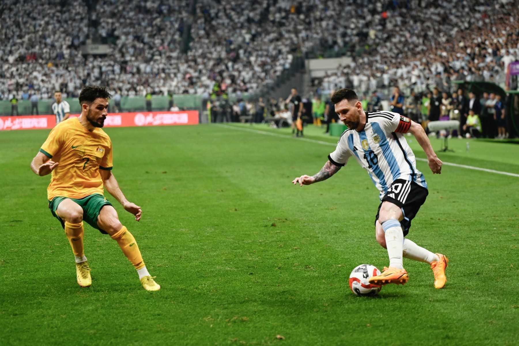 Argentina's Lionel Messi fights for the ball with Australia's Mathew Leckie during a friendly football match between Australia and Argentina at the Workers' Stadium in Beijing on June 15. Photo: AFP