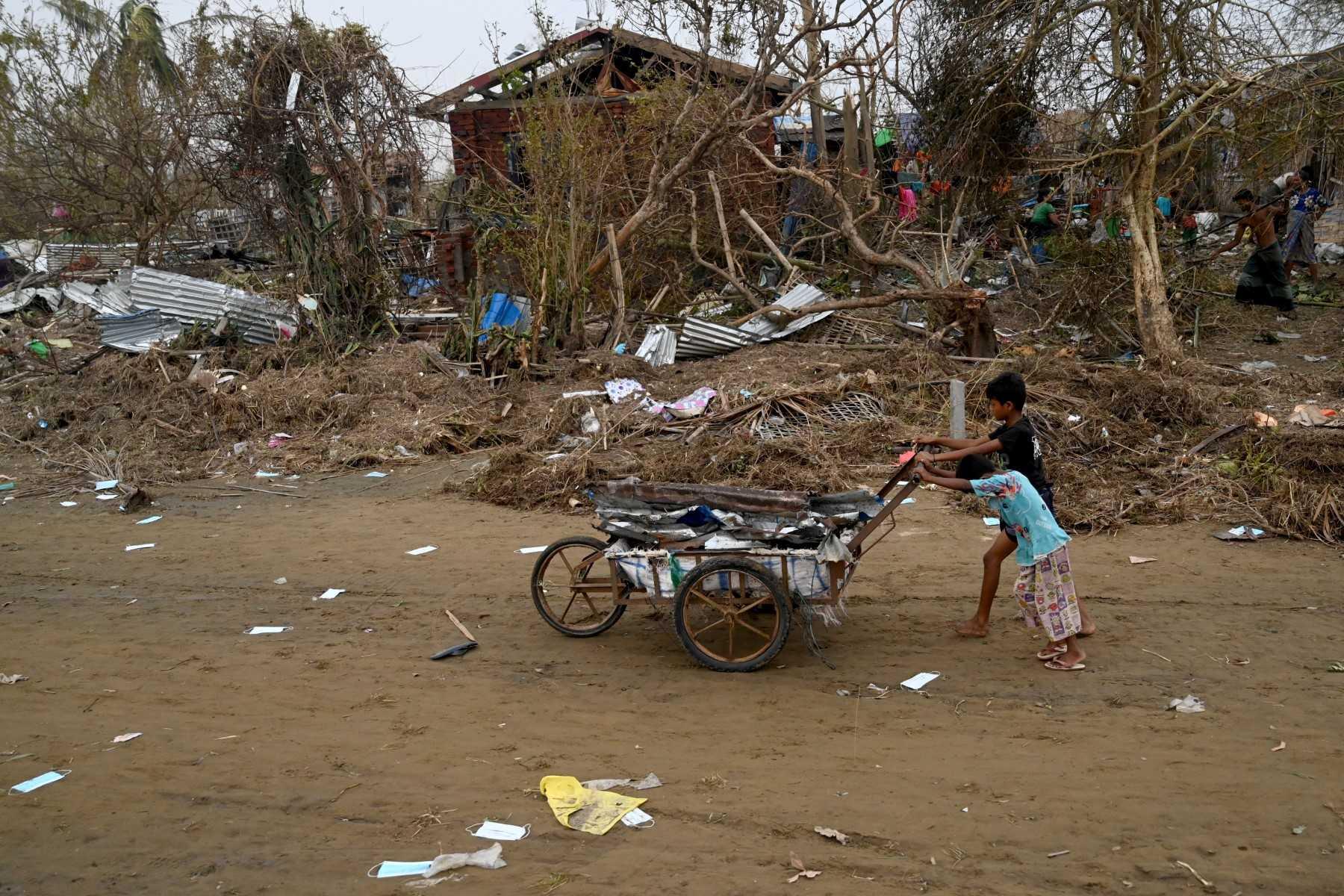 Children push a cart full of debris at the Khaung Dote Khar Rohingya refugee camp in Sittwe, in Myanmar's Rakhine state, on May 15, after cyclone Mocha made a landfall. Photo: AFP