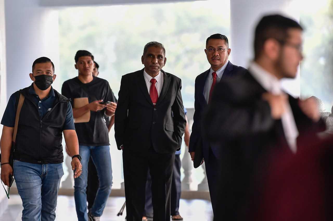 Former treasury secretary-general Mohd Irwan Serigar Abdullah (centre) arrives at the Kuala Lumpur Court Complex today as the 42nd prosecution witness in Najib's corruption trial for money laundering and misappropriation of funds belonging to 1MDB, June 21, 2023. Photo: Bernama
