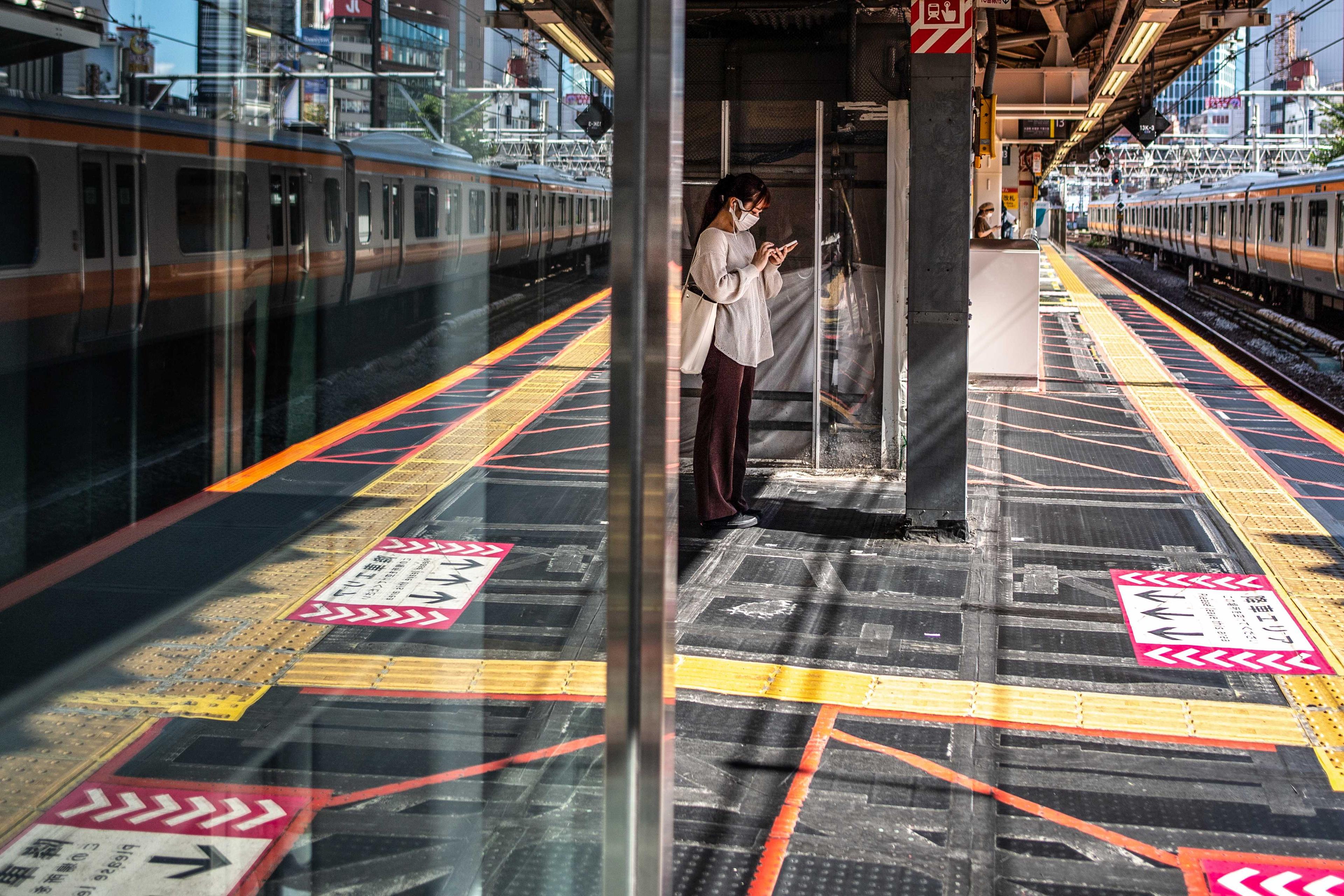 A woman waits for the train at Shinjuku station in Tokyo on July 22, 2021. Photo: AFP