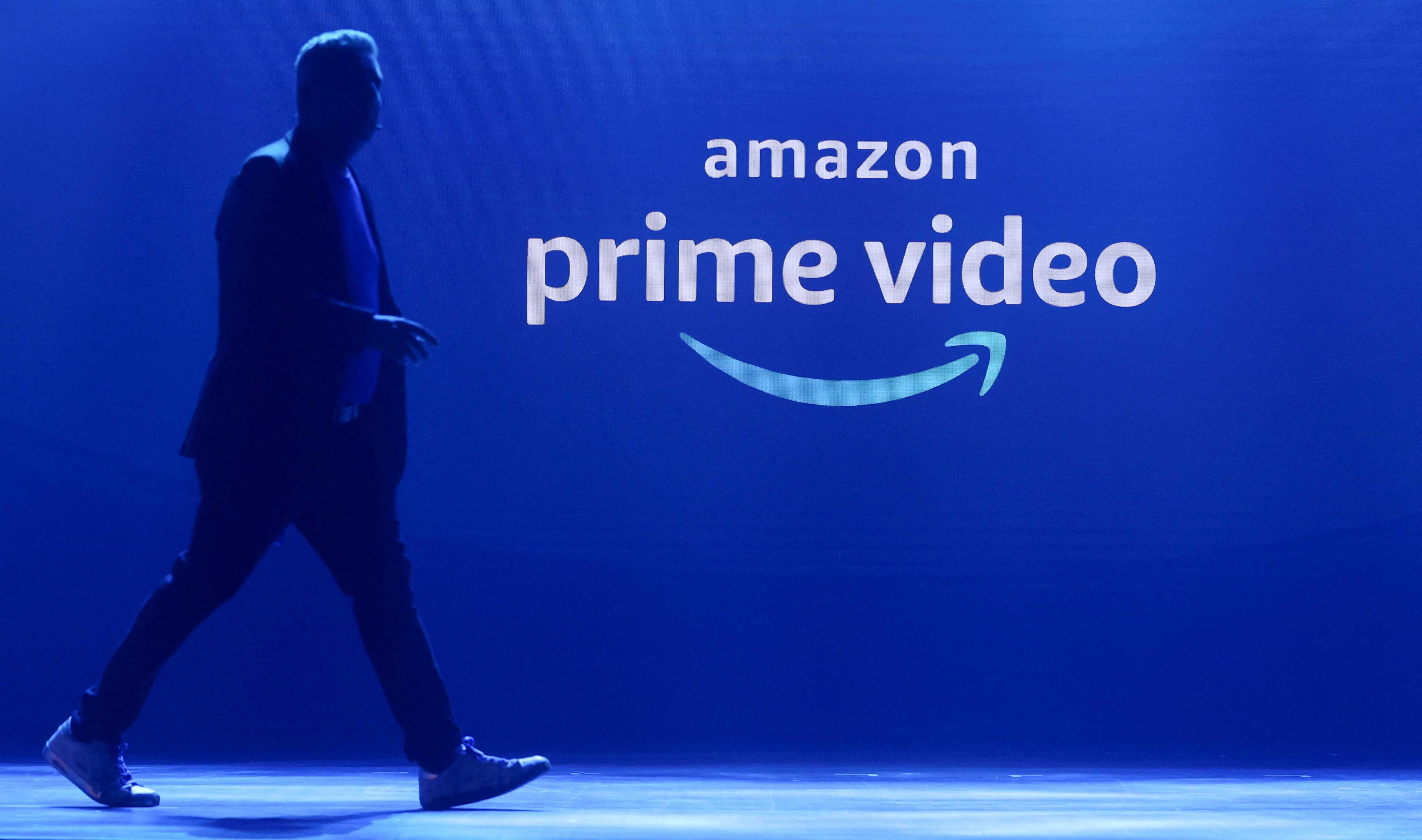A man walks past a logo of Amazon Prime Video during a launch event in Mumbai, India, April 28, 2022. Photo: Reuters