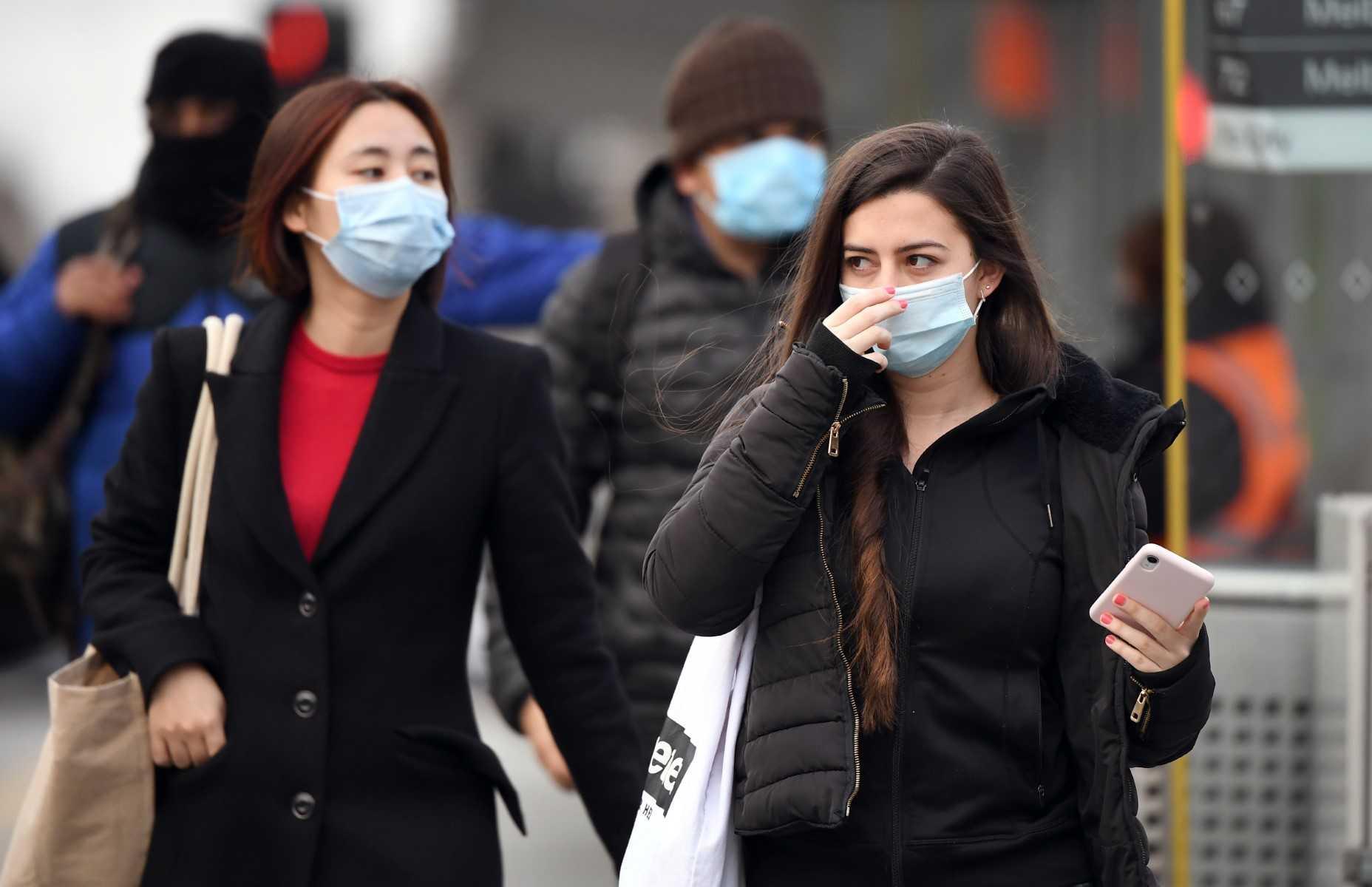 Commuters walk outside Melbourne's Flinders Street Station on July 23, 2020. Photo: AFP
